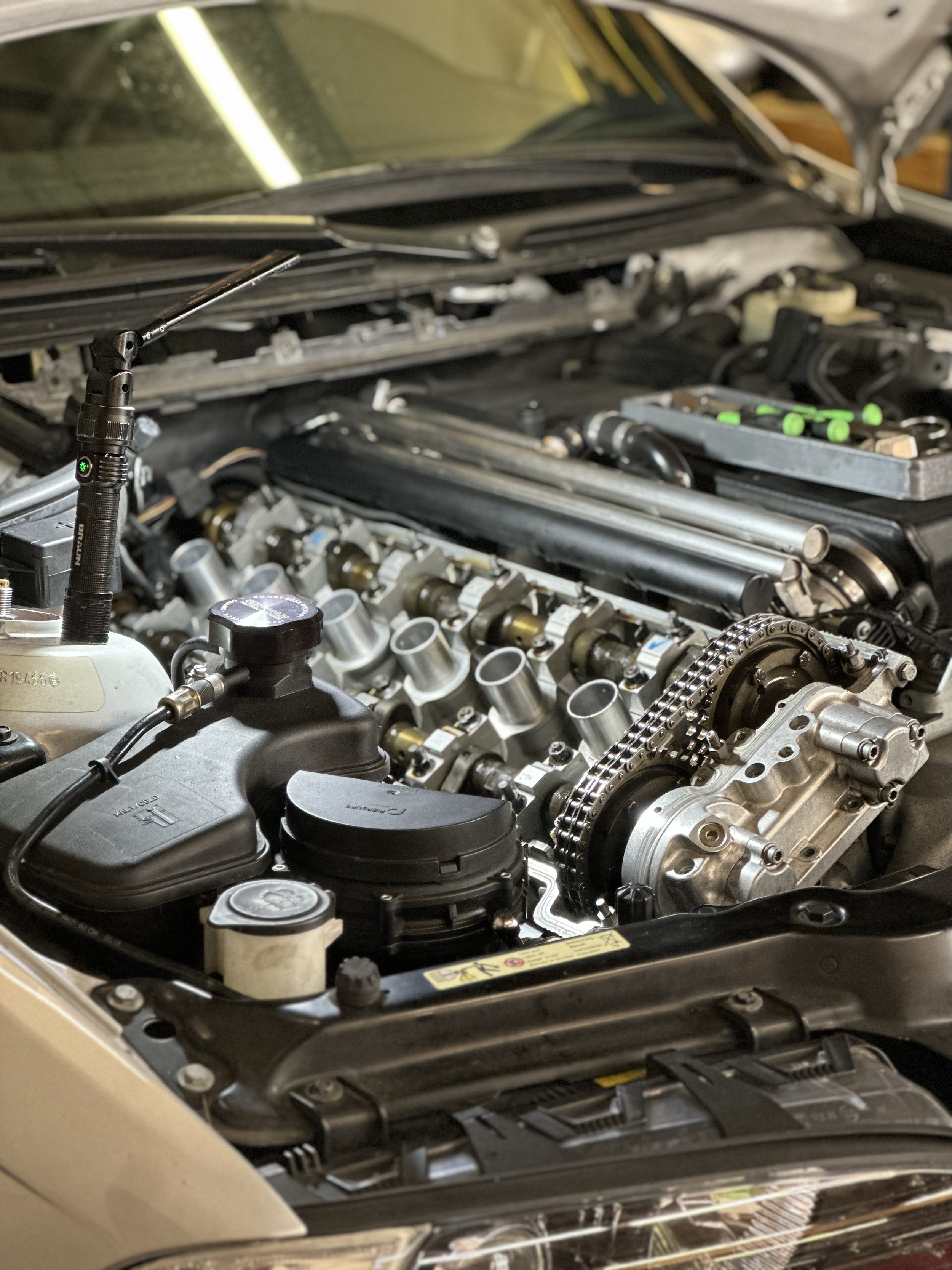 The inside of an engine, specifically the head, where the VANOS is also visible