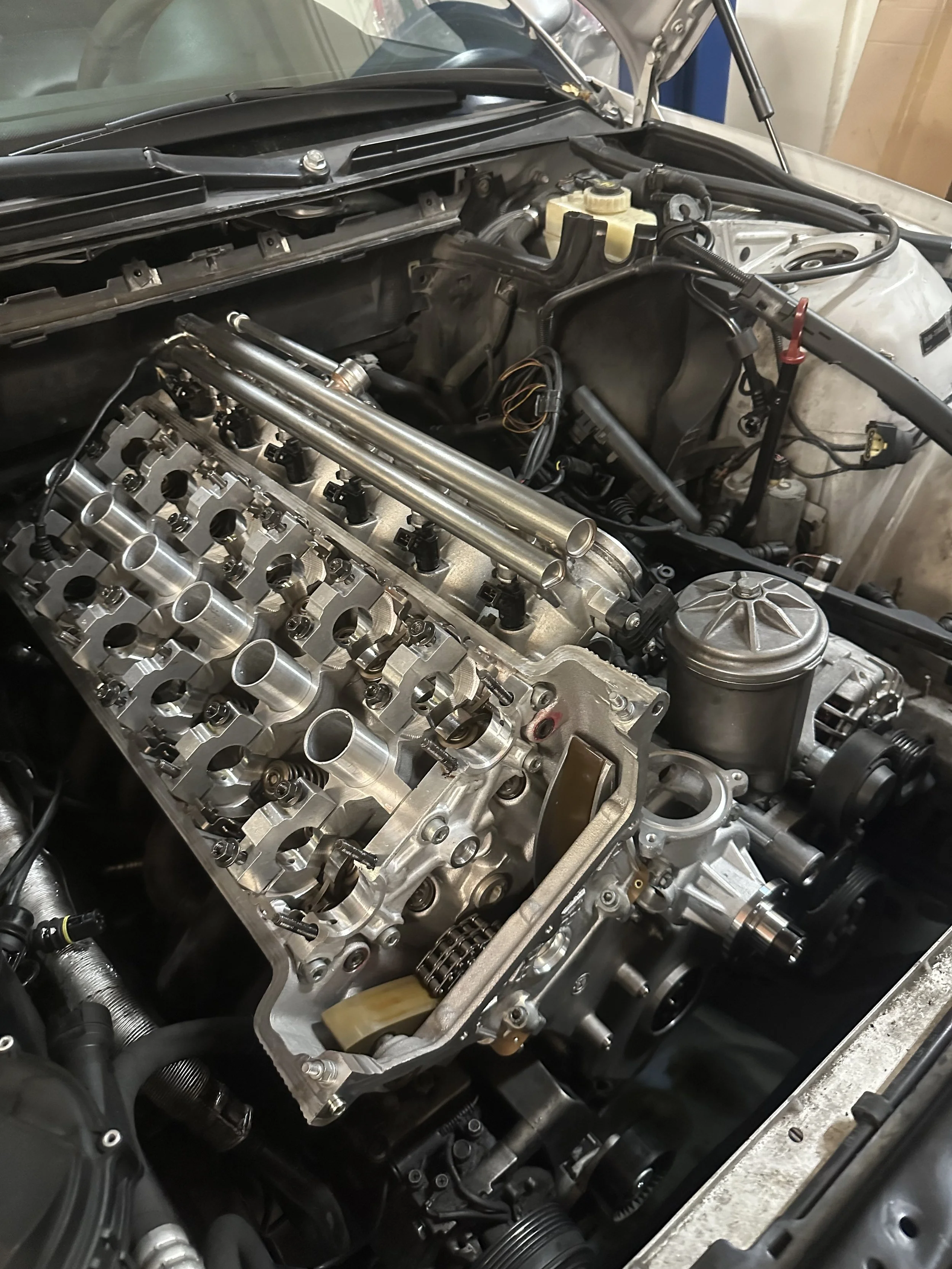 The S54 motor, with its Vanos taken off, in the middle of a valve adjustment on an E46 M3