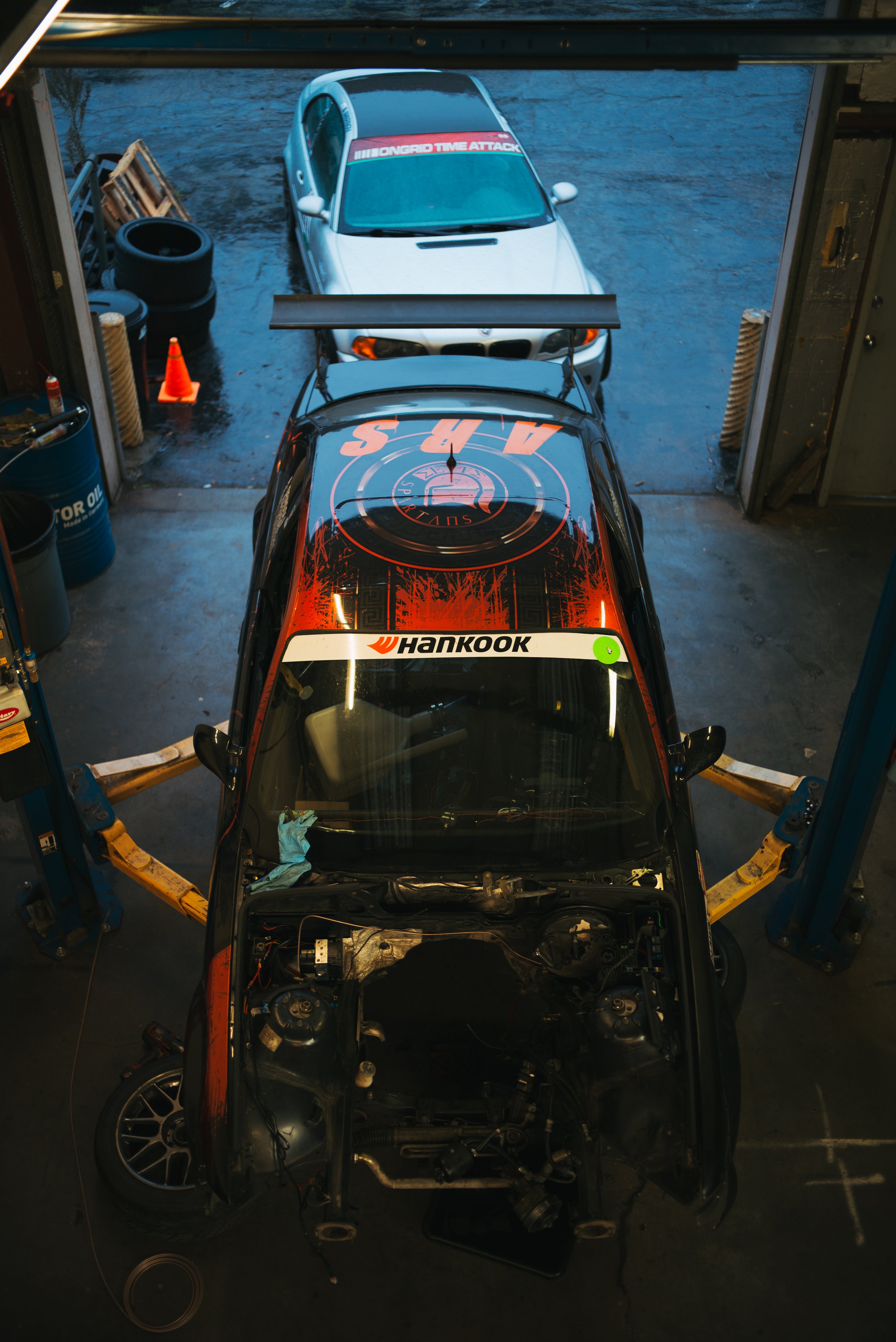 Our E36 M3 racecar being worked on in the shop. This could be your car on our lift!