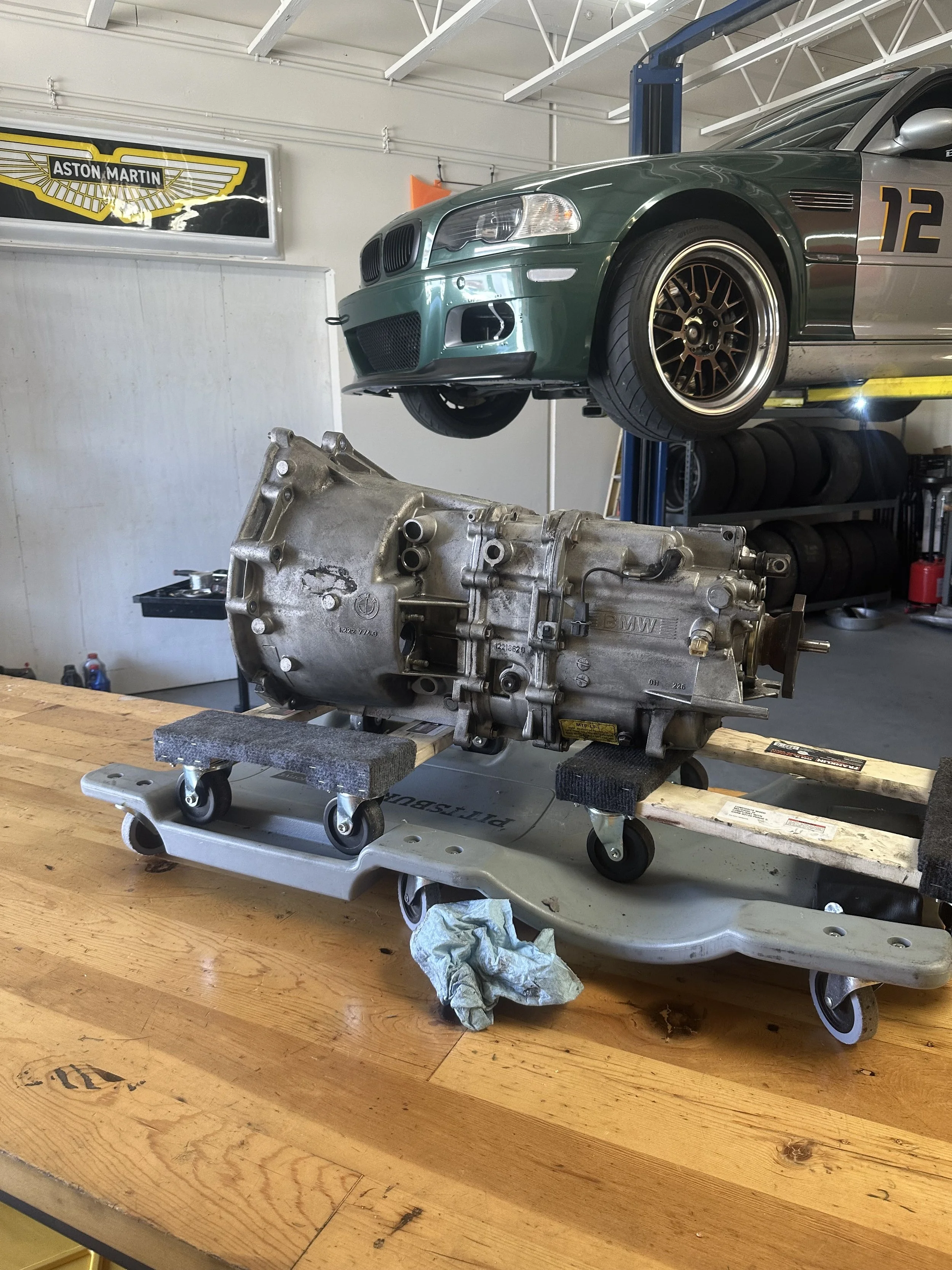 An E46 M3 on the lift while its ZF5 transmission is removed for a clutch replacement job
