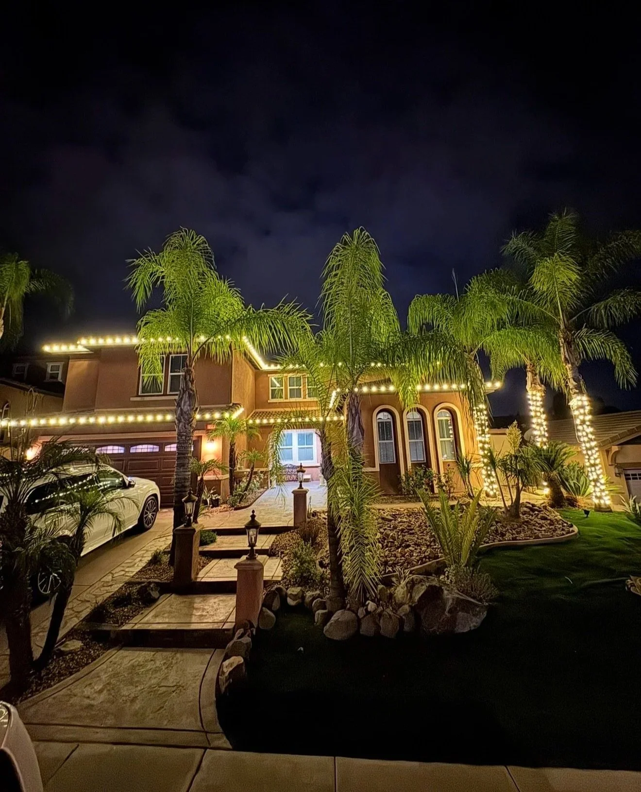 Holiday lighting installation on a home