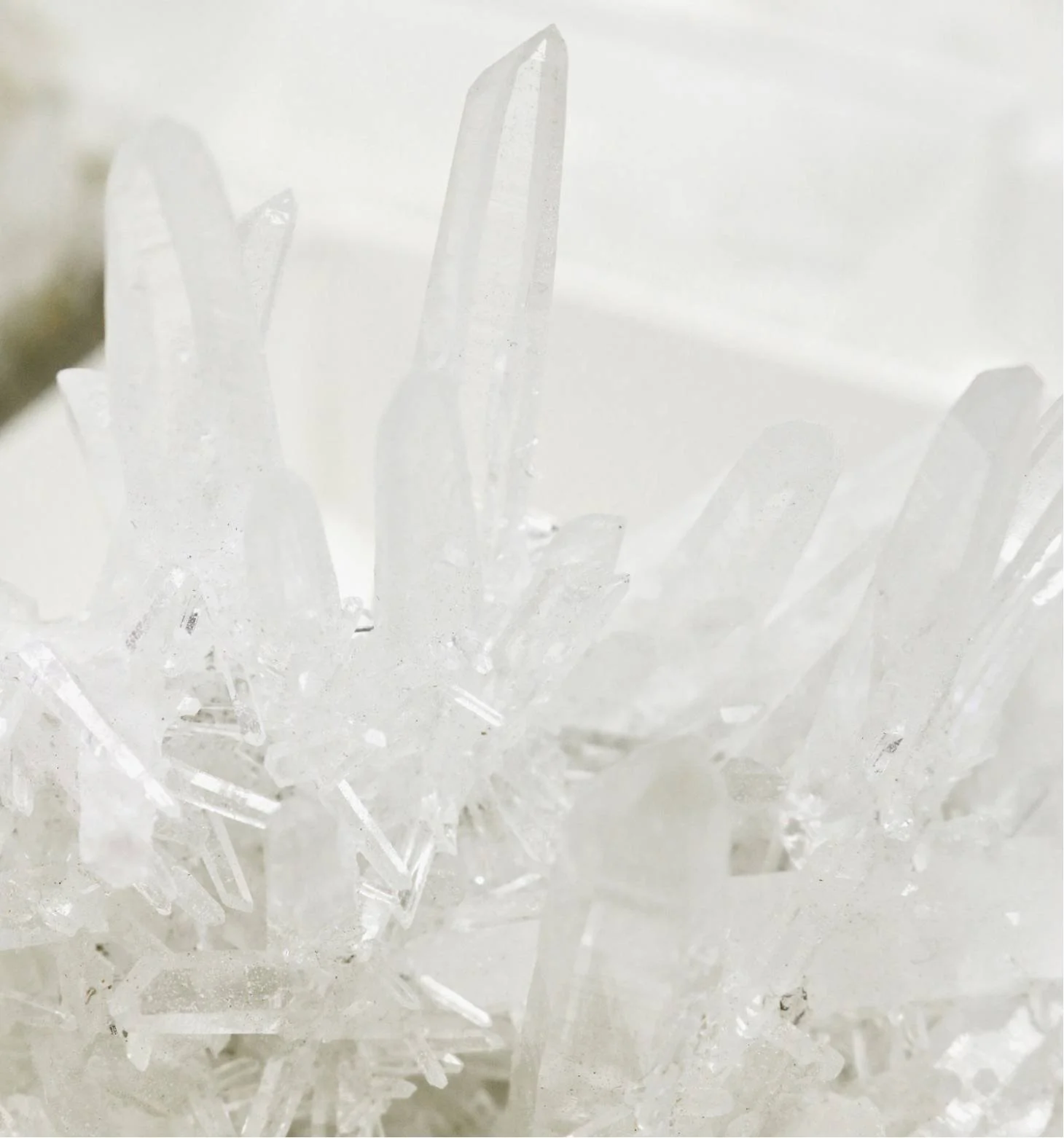Close-up of clear ice crystals with a white background.
