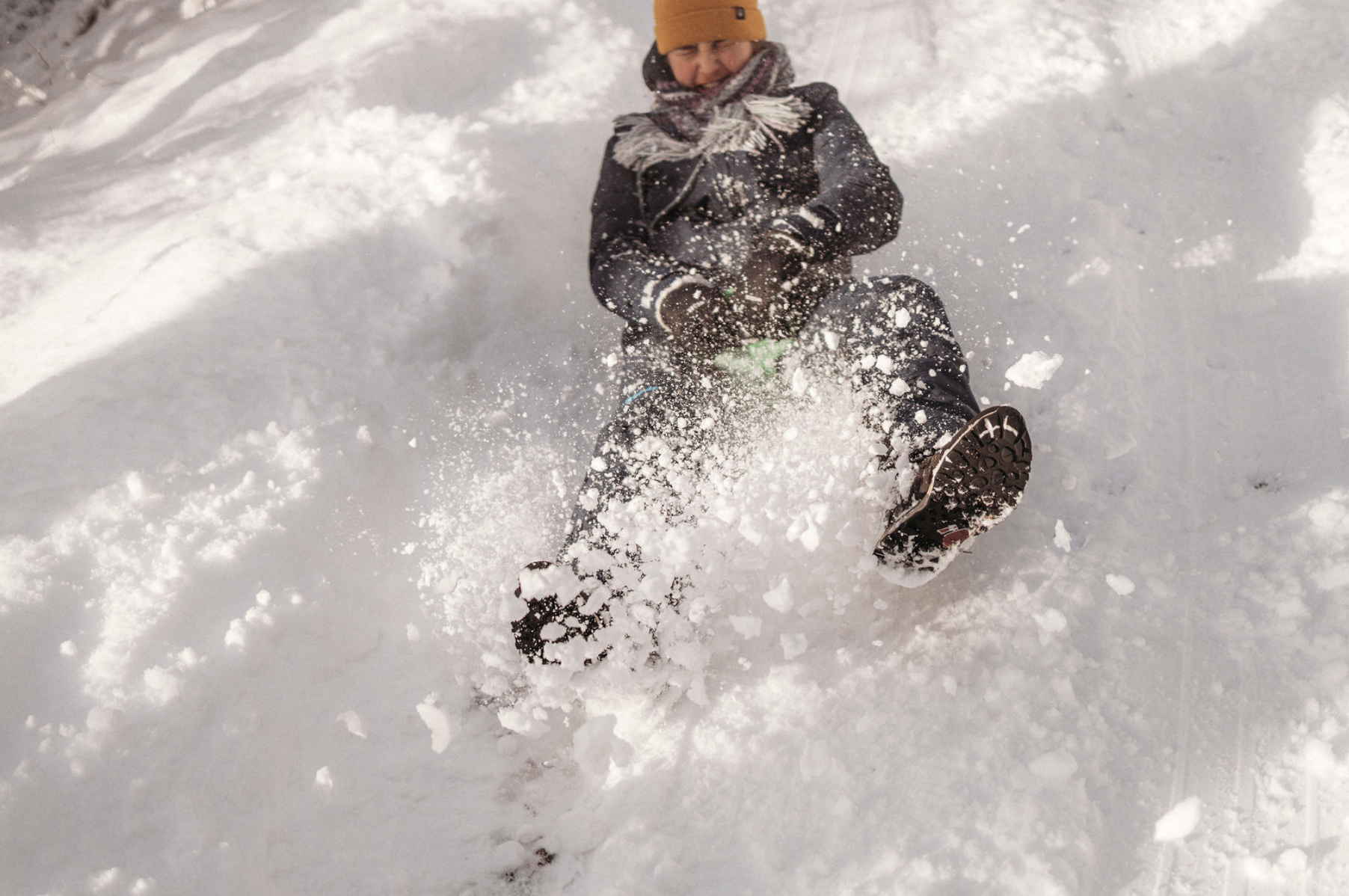 Children playing in the snow in a forest near Ullapool
