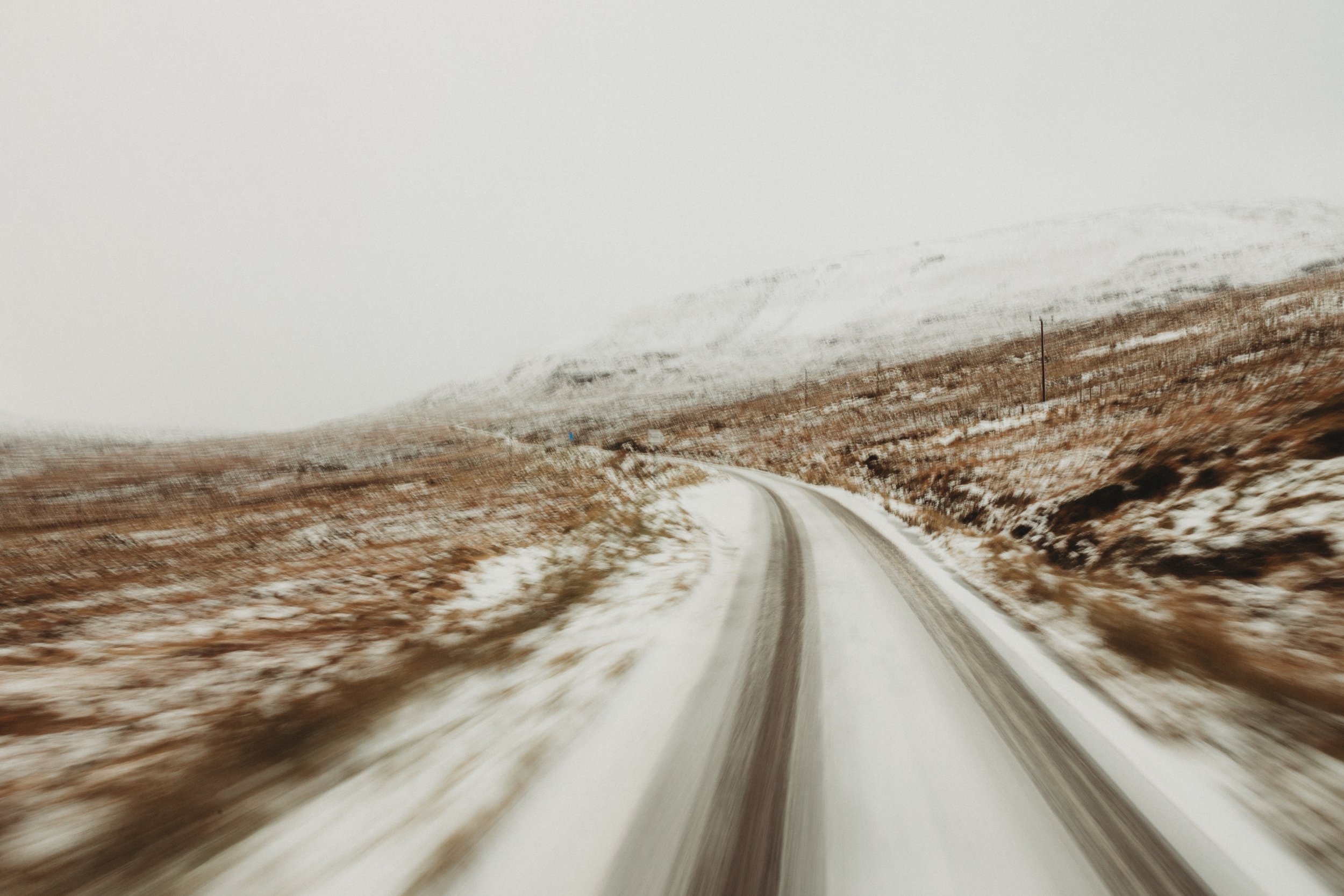 Snowy road leading towards Ullapool in winter