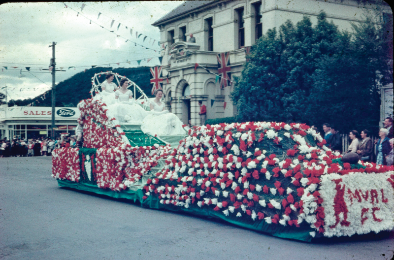 MOSS VALE RUGBY LEAGUE FOOTBALL CLUB FLOAT IN THE STREET PARADE FOR THE FESTIVAL OF FLOWERS IN 1959 (THE BUILDING ON THE RIGHT, THE CBC BANK ON THE CORNER OF BONG BONG AND MERRIGANG STREETS, WAS DEMOLISHED AT THE END OF 1959).