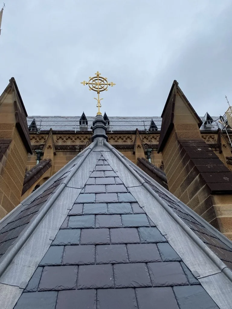 Leadwork including lead Hips leading up to a bespoke lead finial on a cathedral in Sydney