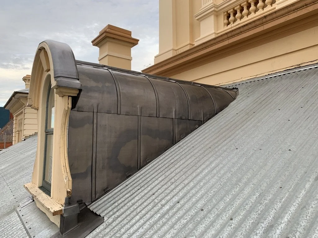 Curved Lead dormer with lead weathering and flashings on metal roof