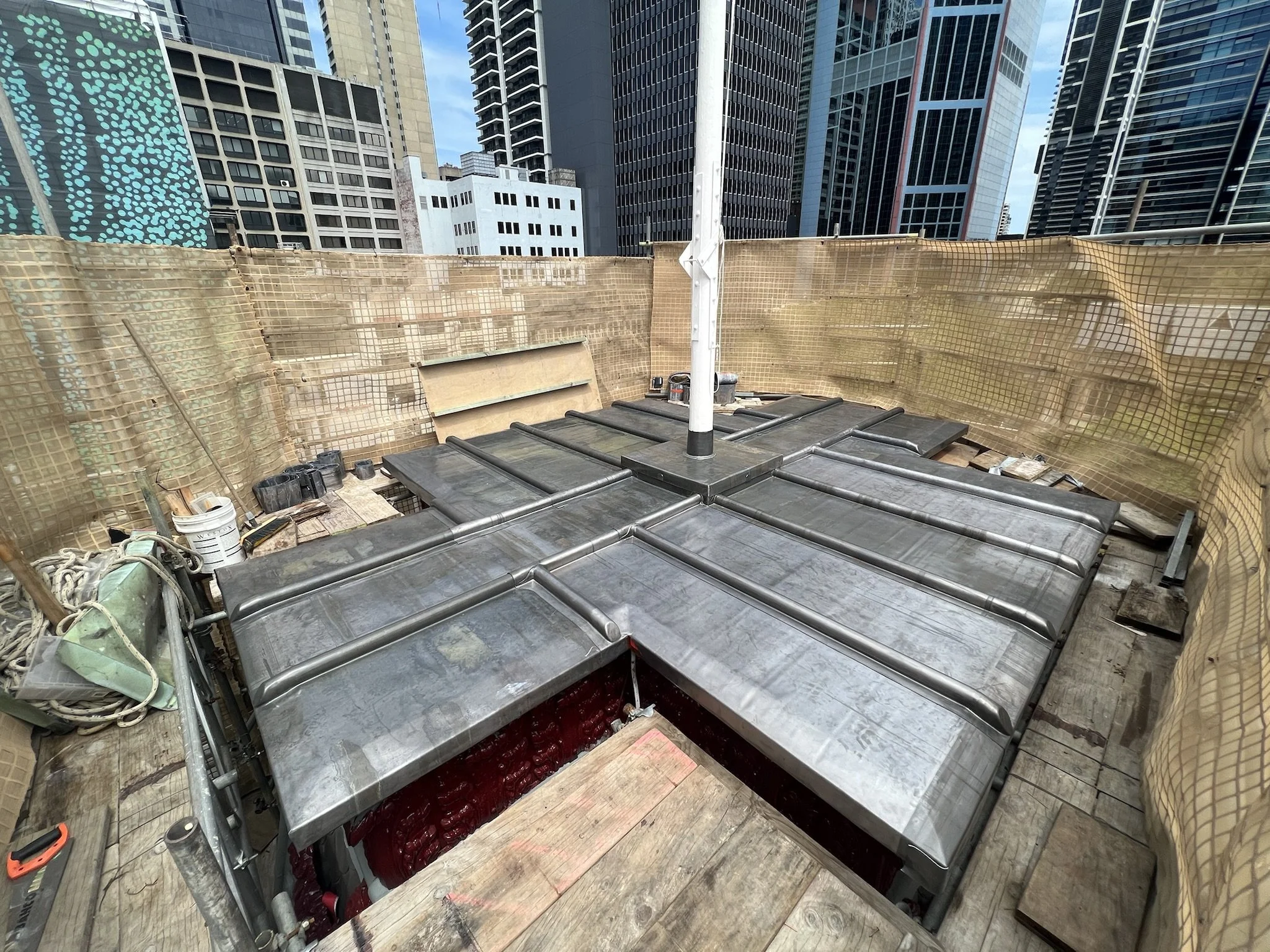 Lead roof with lead roll joints with a flag pole in middle and lead weatherings