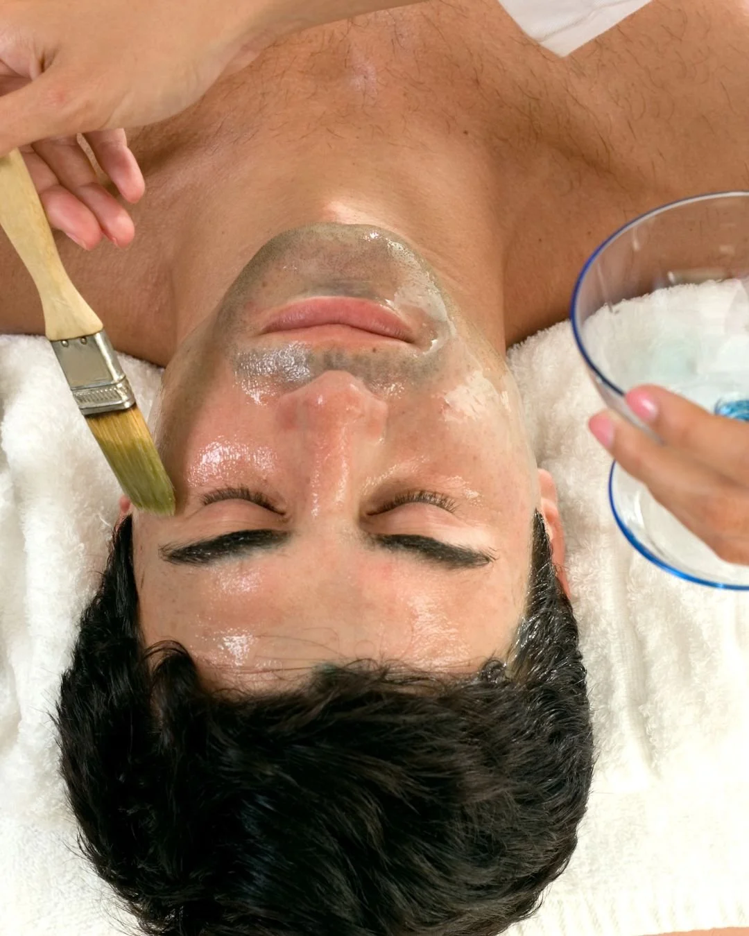 Man lying down with a facial chemical peel