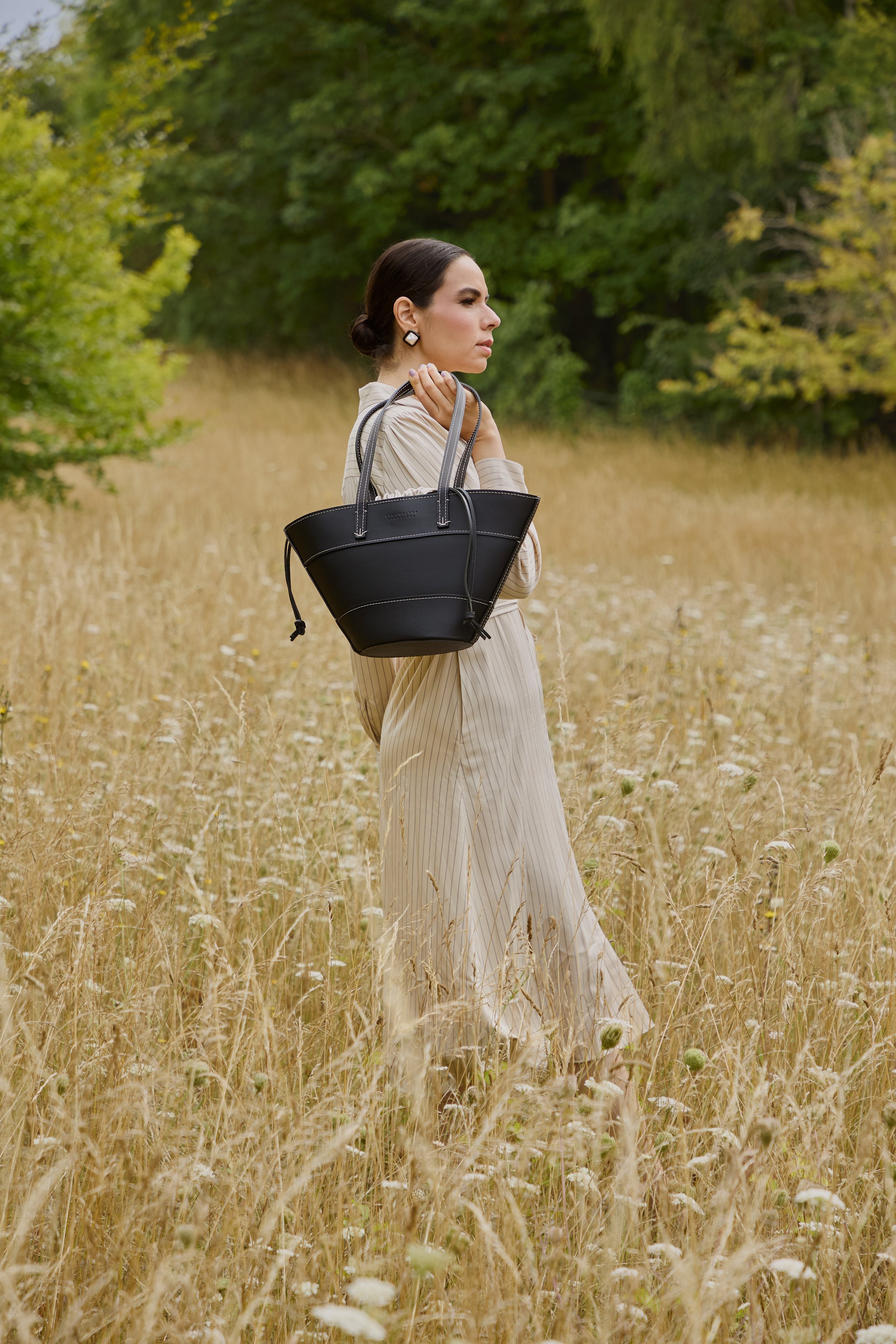 Rohiny Belani wearing the Black Margot Tote Bag.