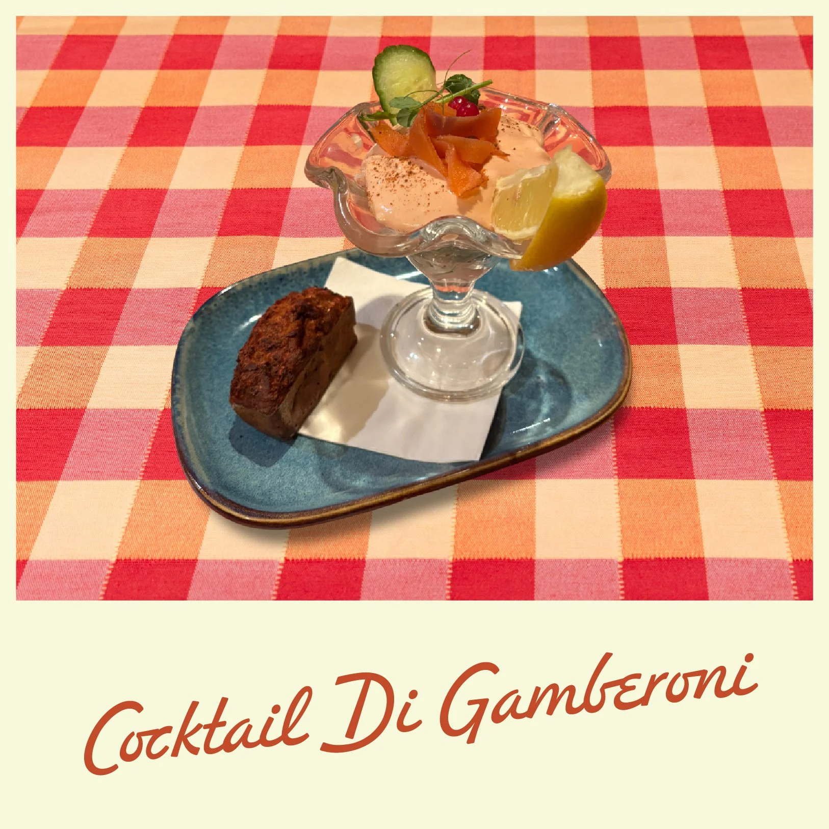 A pizza topped with arugula, dollops of white cheese, and possibly roasted vegetables on a plate, set on a red and yellow checkered tablecloth.