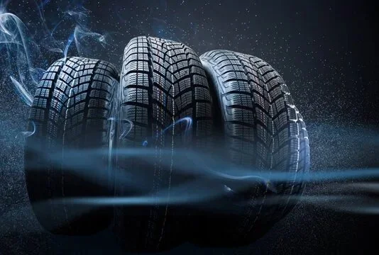 Three car tires with a space-themed background and neon blue accents.