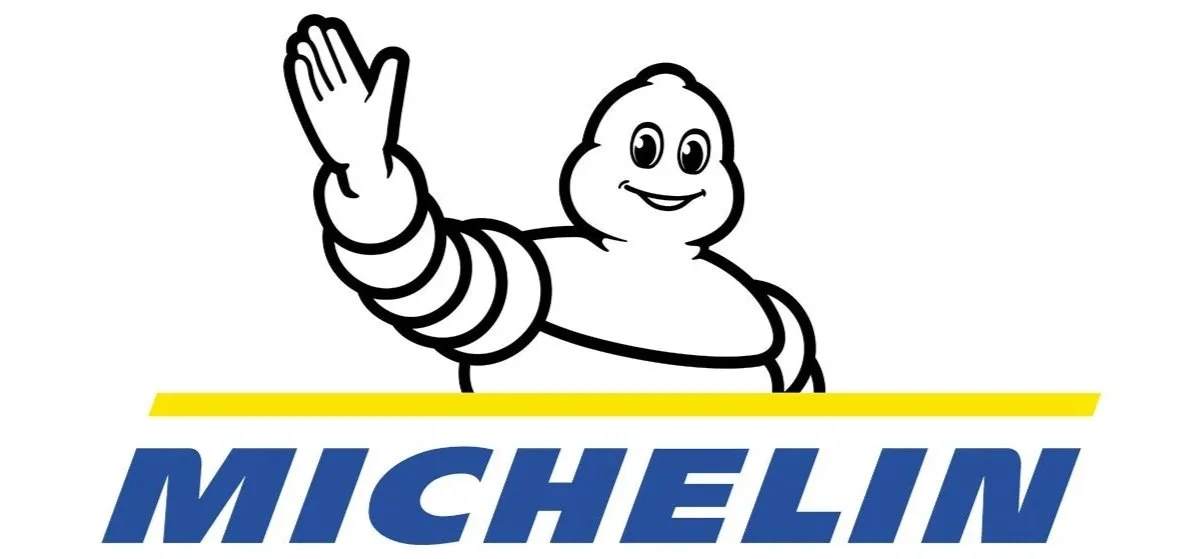 The Michelin mascot, Bibendum, waving with a smile, above the Michelin logo in blue and yellow.