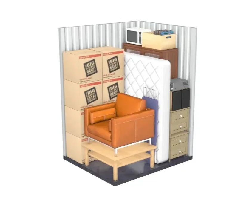 A miniature room packed with furniture and boxes, including a brown leather chair, a mattress, a microwave, a wooden cabinet, a small filing cabinet, a speaker, and several boxes labeled 'Big Self Storage'.