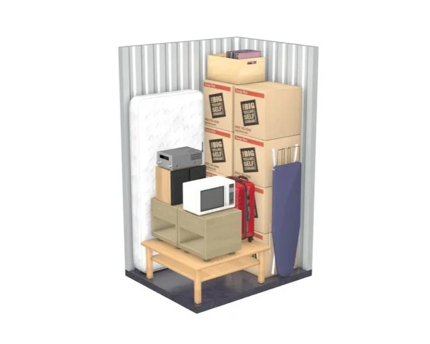 A storage room with boxes, a microwave, an iron, a bed frame, an iron box, and an ironing board.