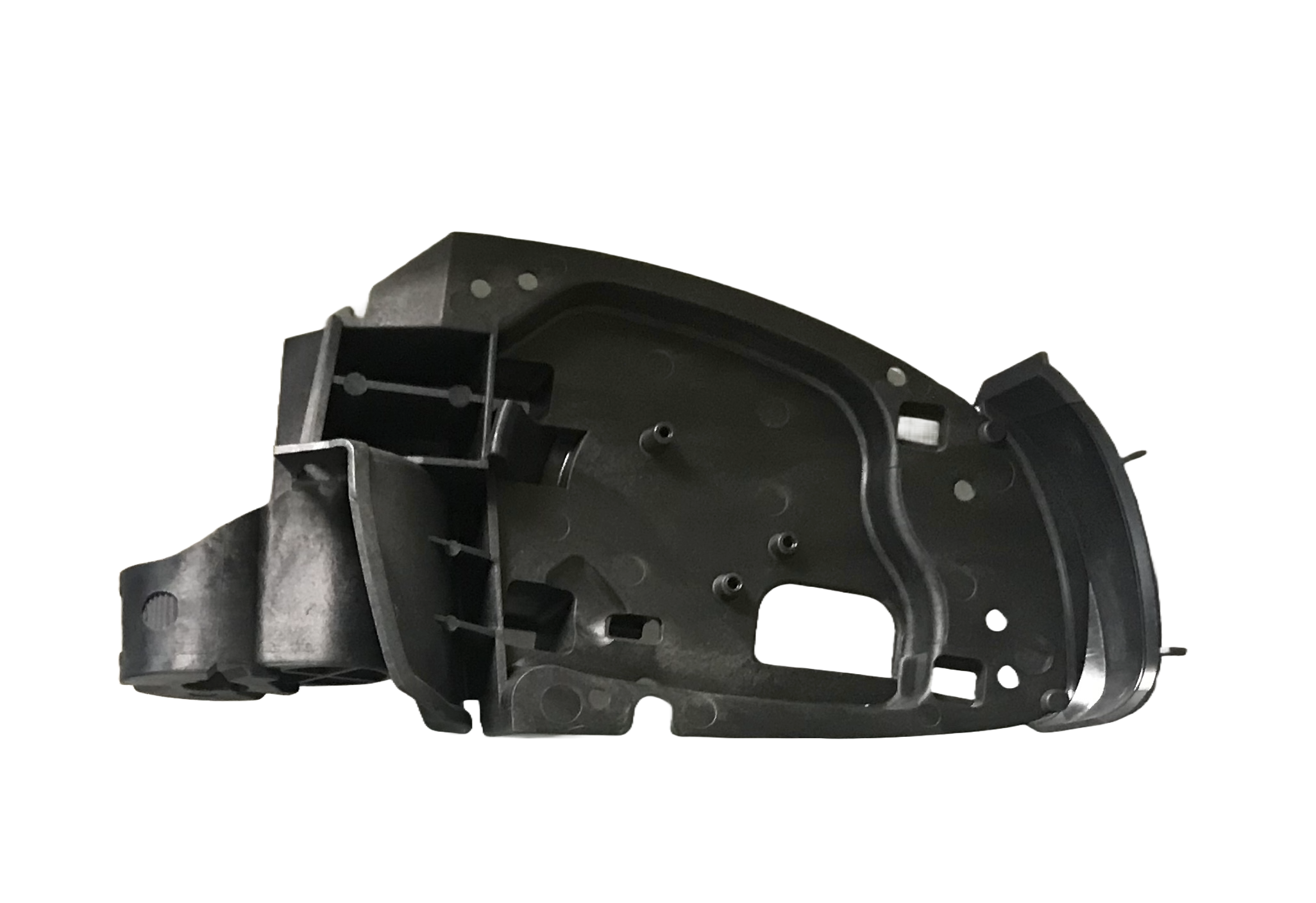 A black plastic mechanical or electronic component with various holes and structures, isolated on a white background.