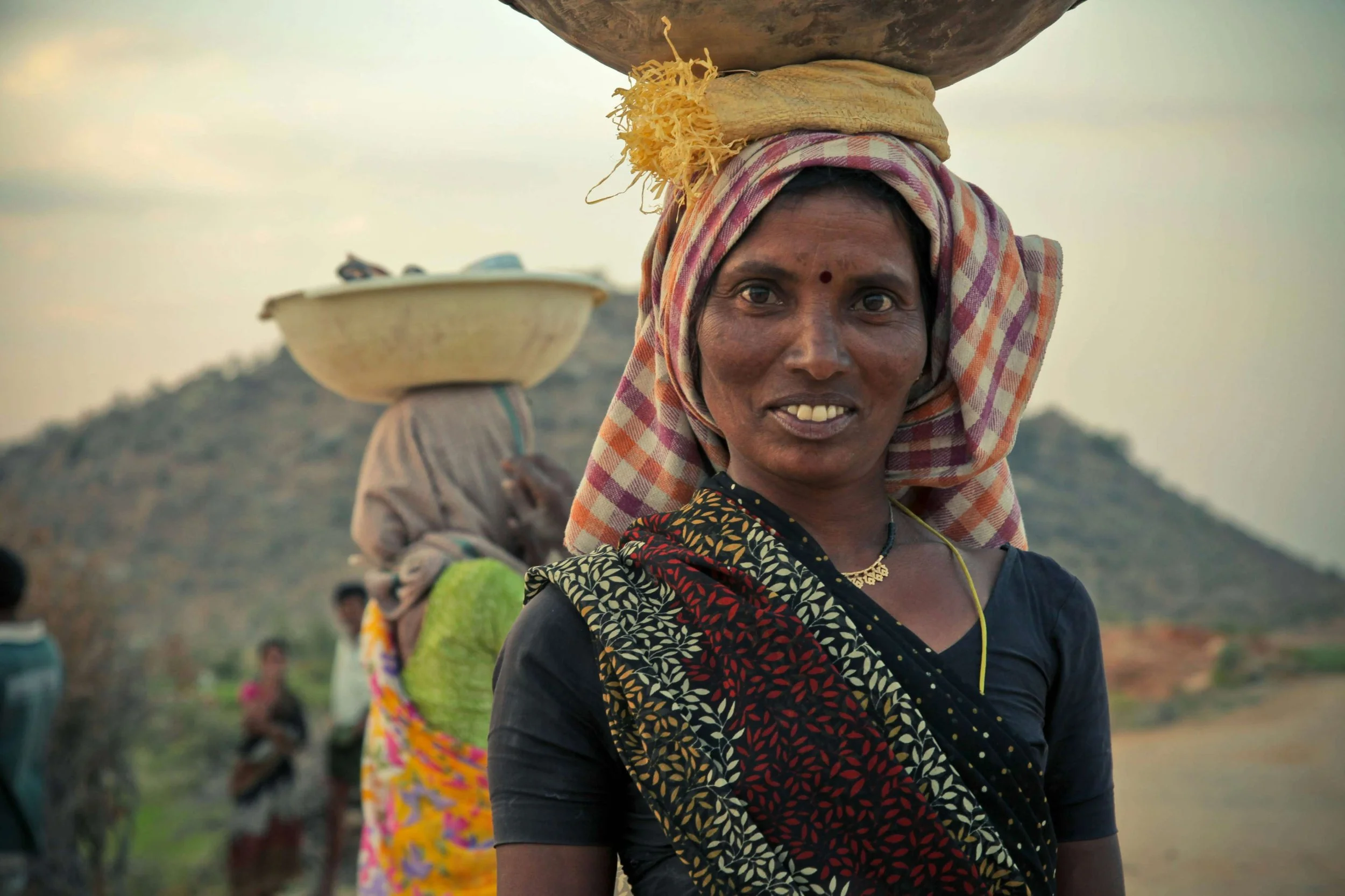 woman carrying basmati rice and other perishables on her head
