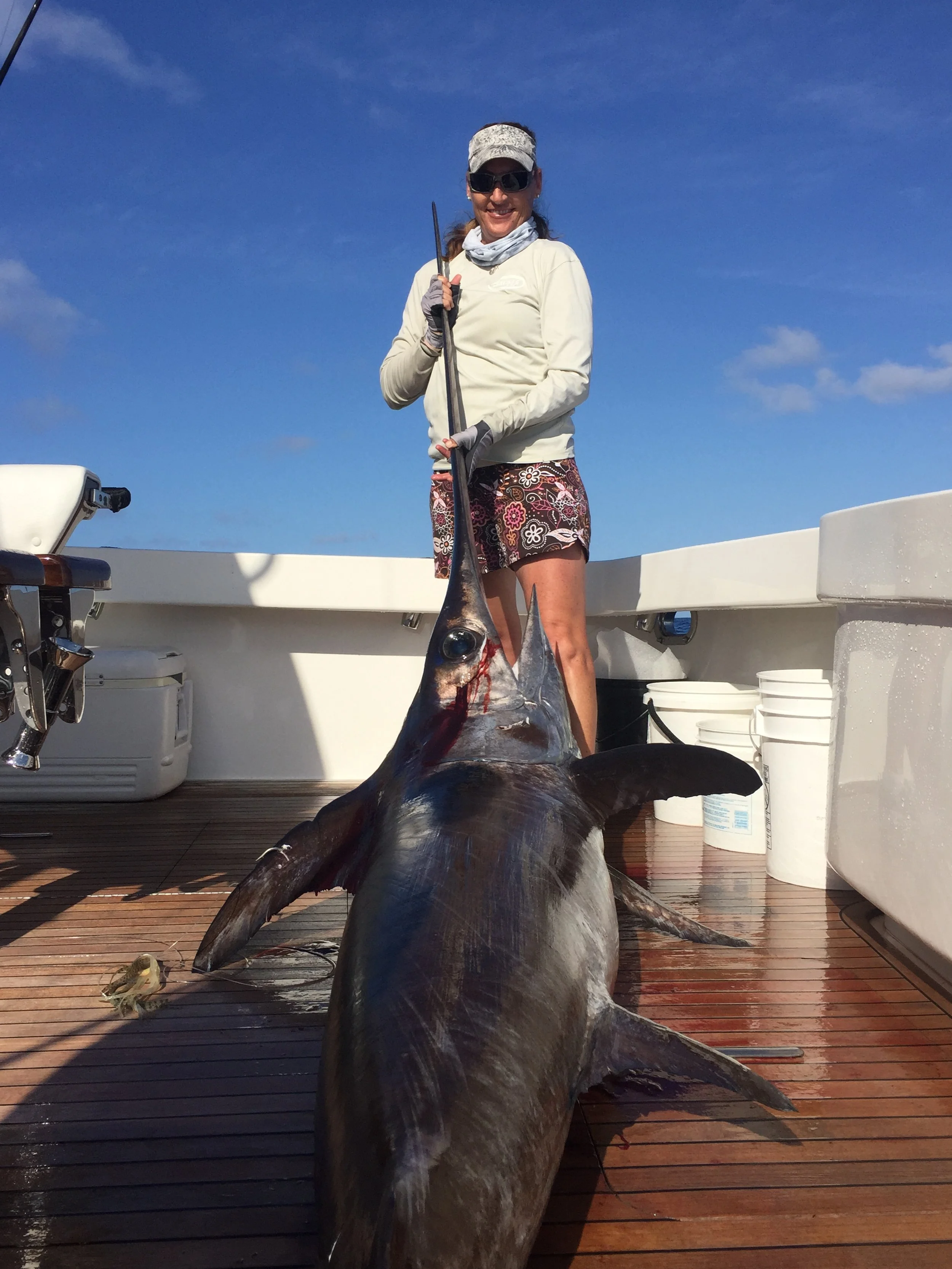 Capt. Jen Copeland holds up her double-marker swordfish while deep-dropping off the Florida coastline.