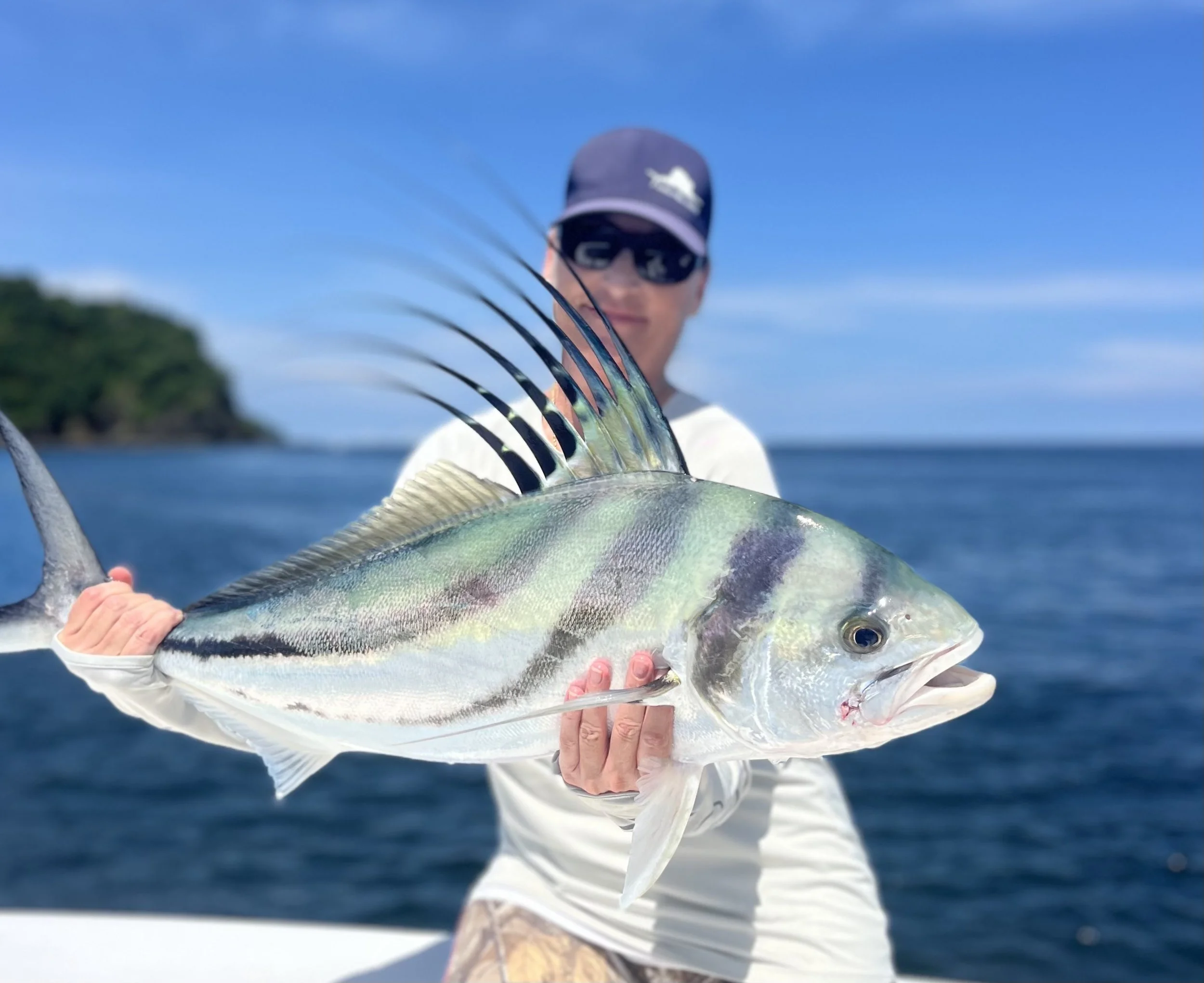 Capt. Jen Copeland holding a roosterfish off the quiet islets of Flamingo, Costa Rica.