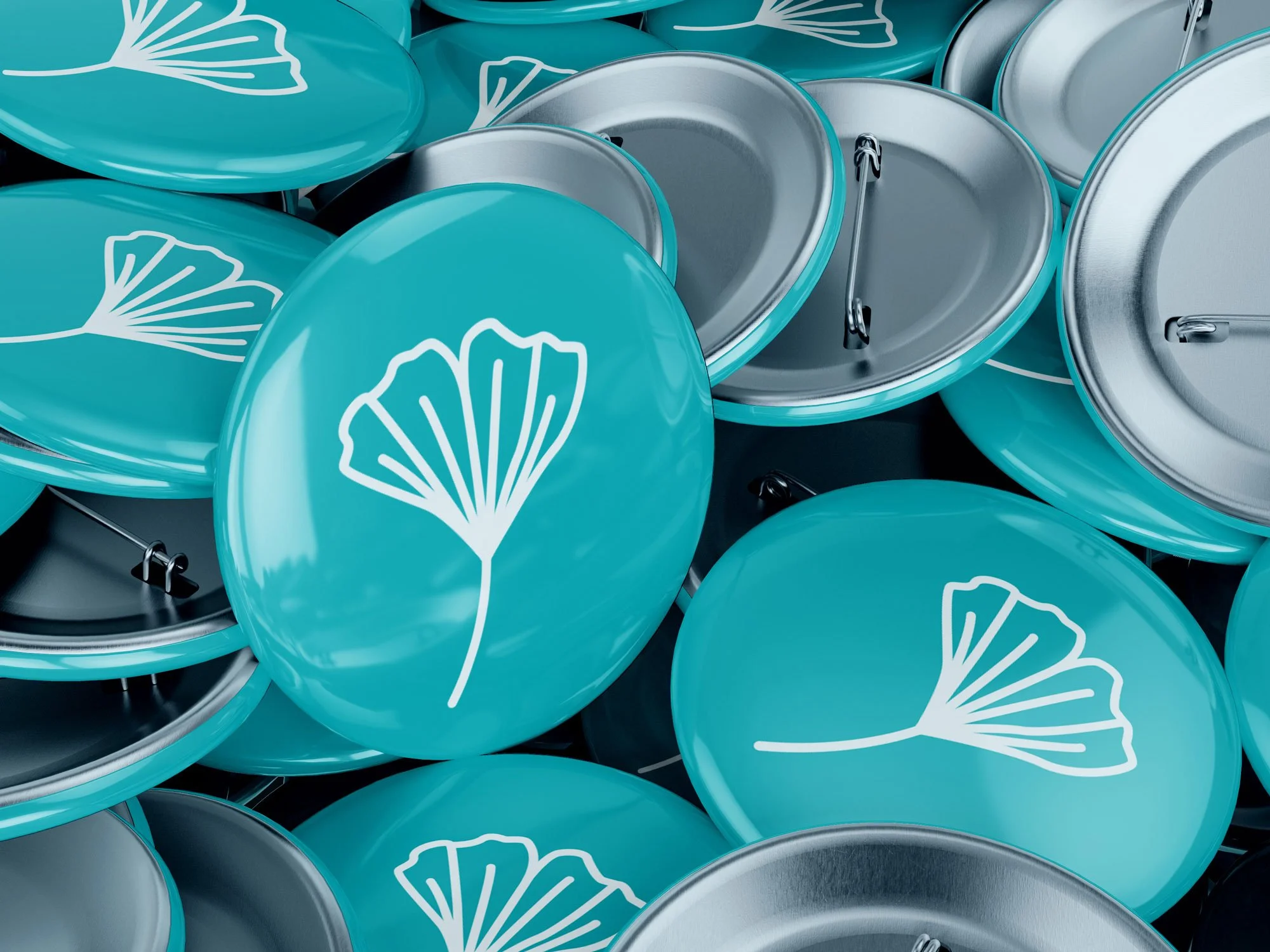 Individuell gestaltete Buttons mit Ginkgoblatt-Illustration als Werbemittel.