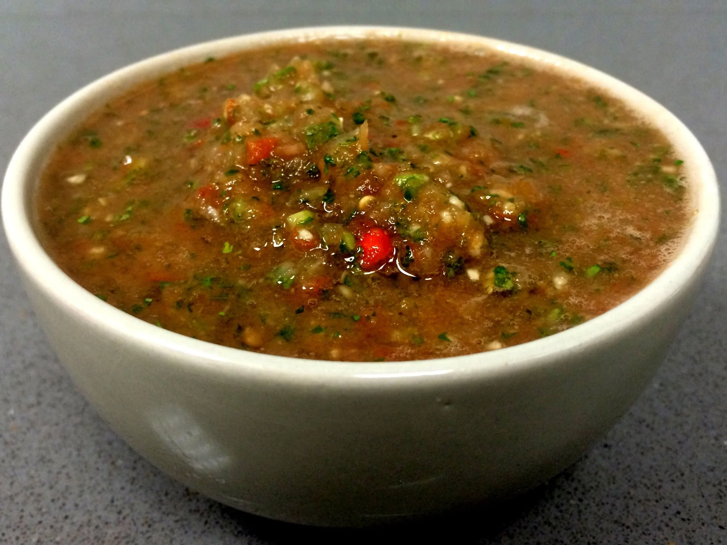 Bowl of chunky salsa with chopped vegetables and herbs