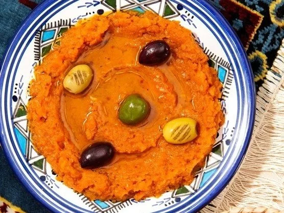 Traditional Moroccan orange sweetened mashed carrots topped with syrup and decorated with four colored candy-coated almonds.