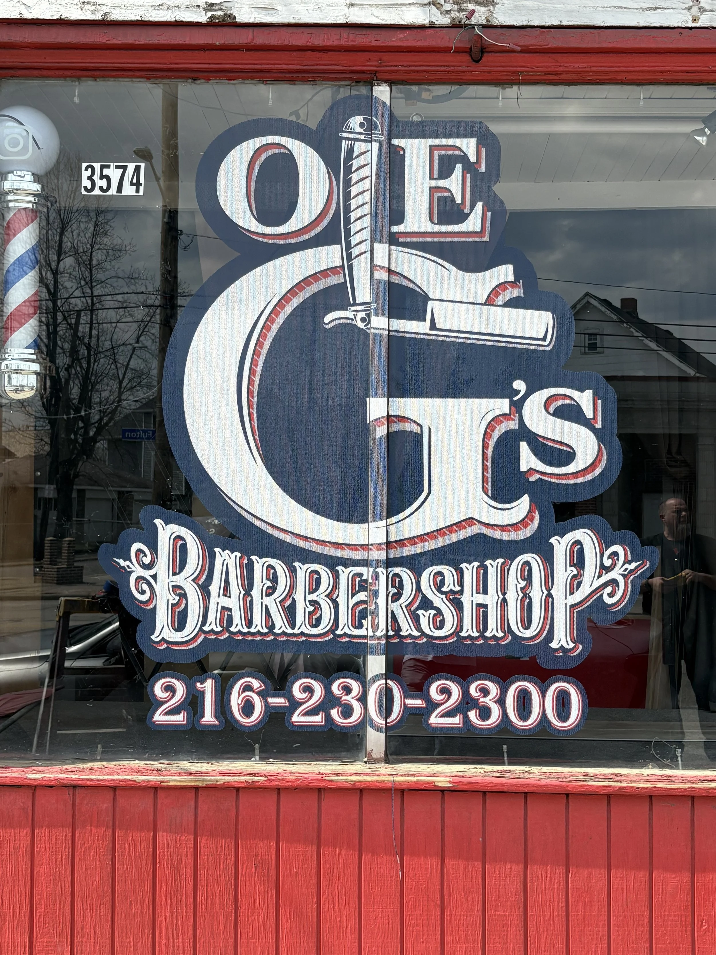 Sign for a barbershop with a traditional barberPole, barber scissors and comb graphic, and contact phone number.