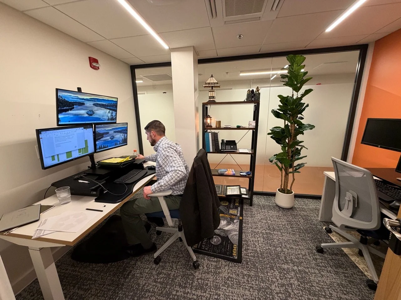 Man sitting in a private office at a desk at The Wedge working on his laptop