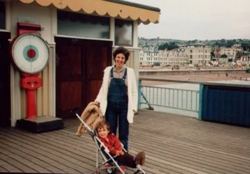 Mum and a young me in a pushchair.jpg