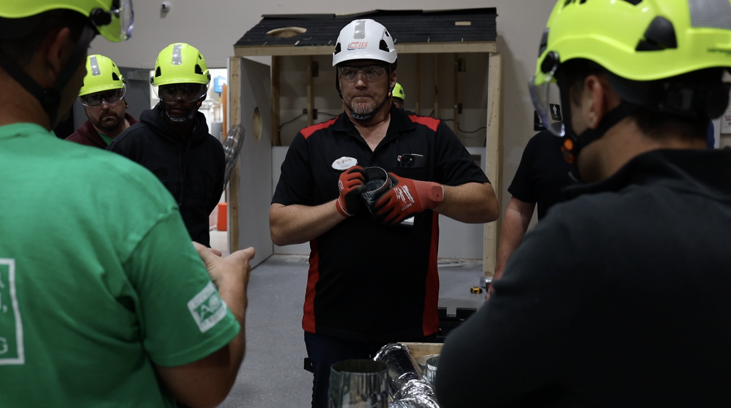 An instructor holding a dryer vent