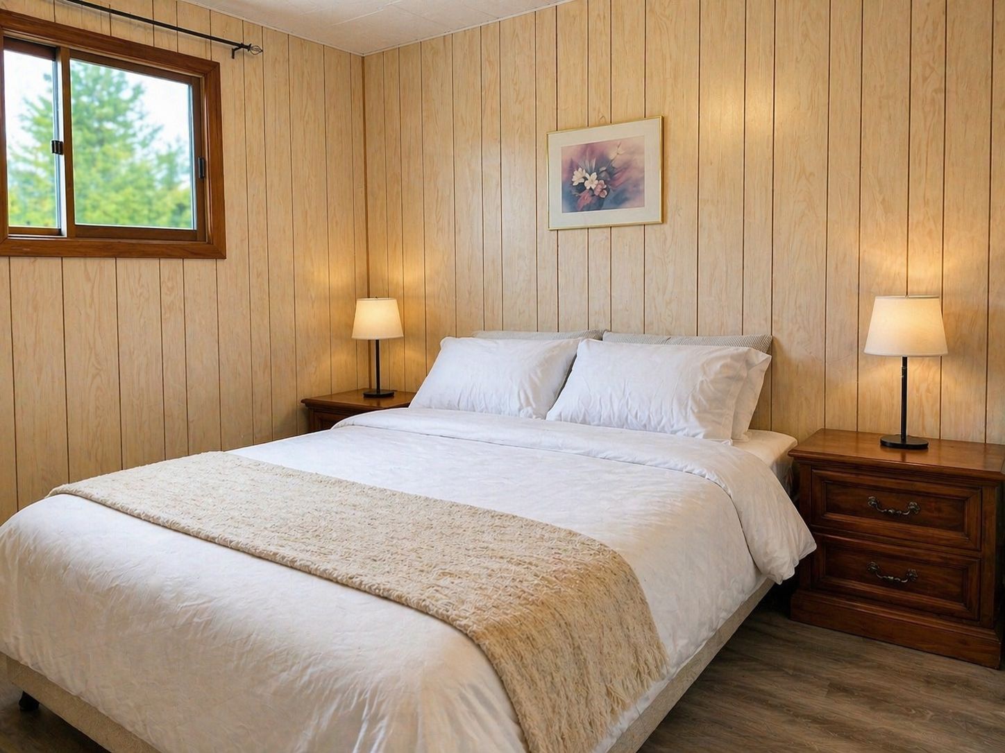 Master bedroom with a cozy interior that includes a queen bed, night stands, night lamps.