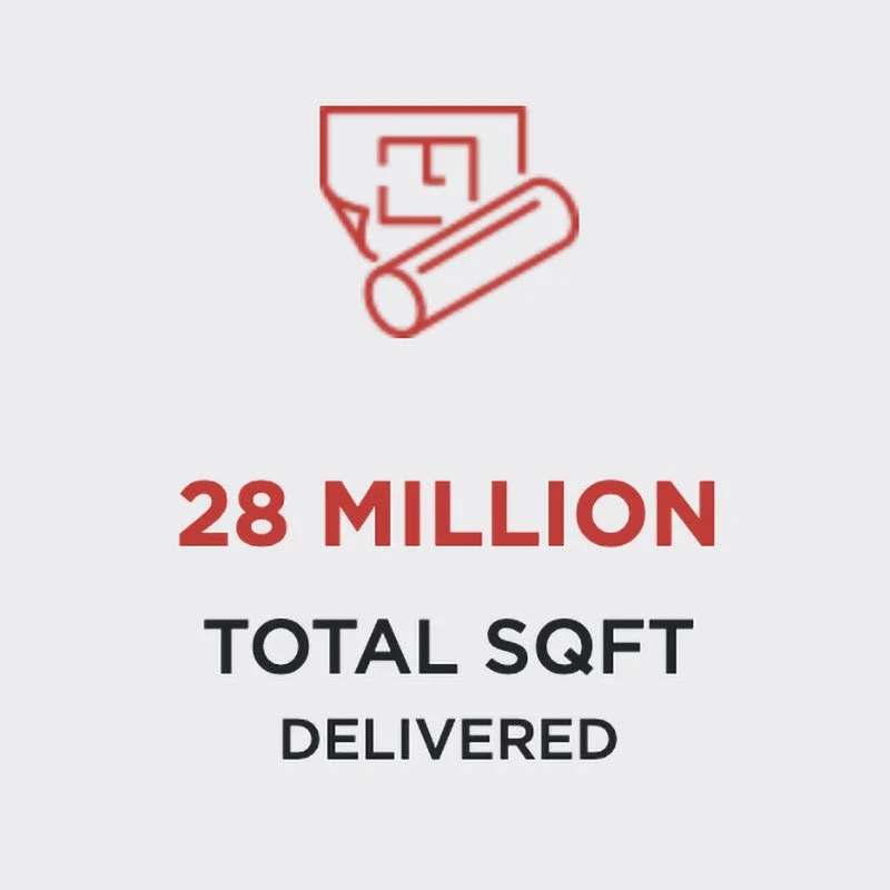 A graphic showing a red outline of a house and a rolled-up blueprint or paper above the text "28 MILLION TOTAL SQFT DELIVERED" in bold red and black letters.