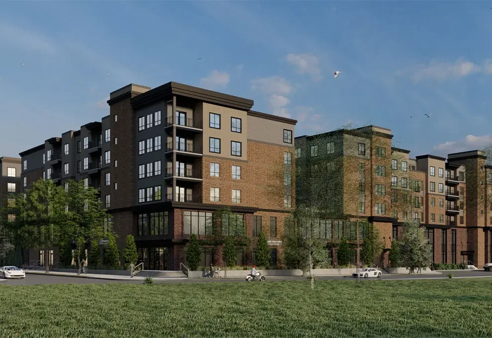 The Mark Fort Collins by Landmark Properties – a modern multi-story apartment building with brick and grey exterior, large windows, balconies, green trees, cars parked in front, and a grassy area under a partly cloudy sky.