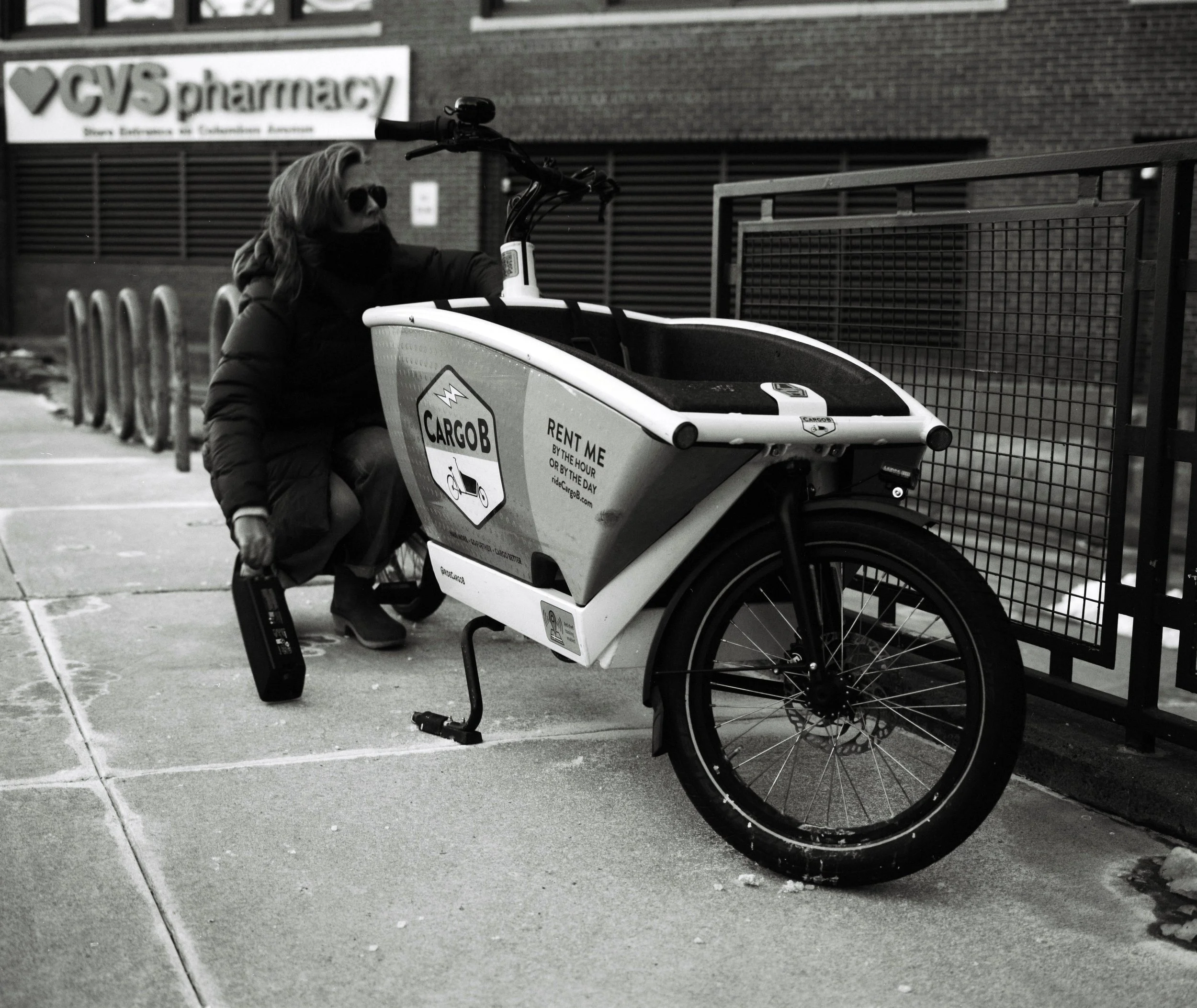 Dot Fennell replacing a battery on one of CargoB's cargo bikes in Boston's South End