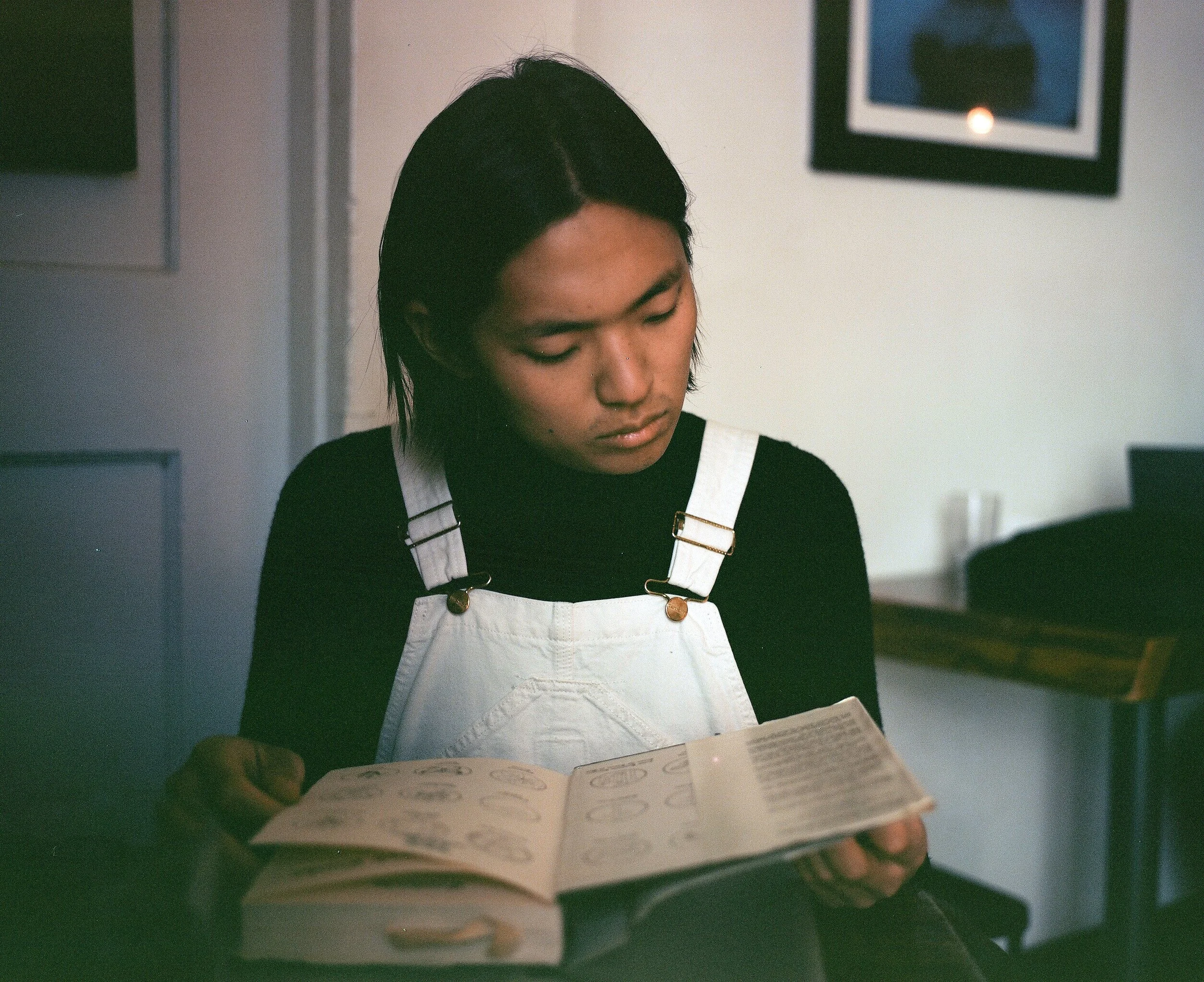 A portrait of someone reading a book at a quiet space