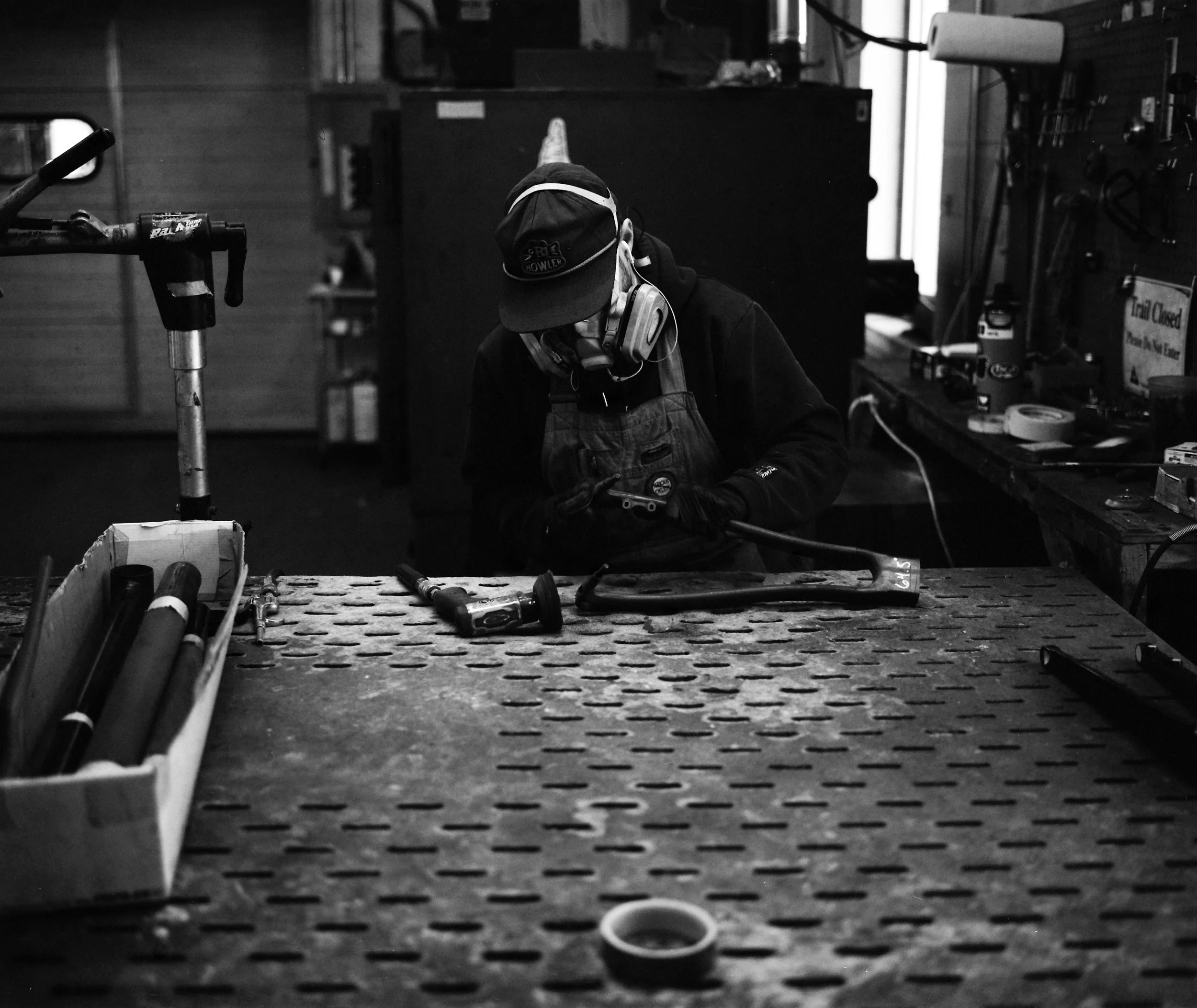 a Parlee team member sands a fork