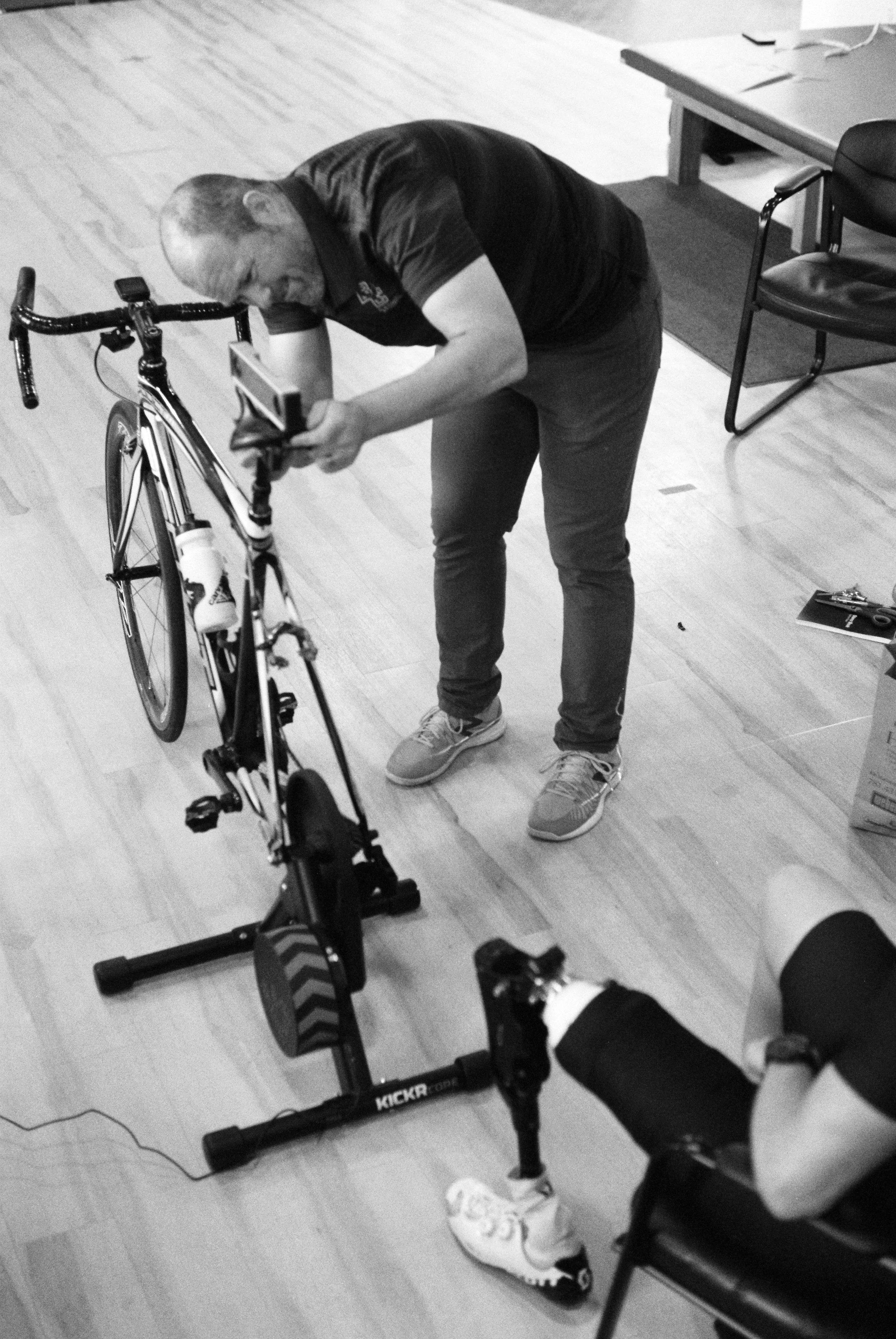 Mike adjusts Dave's bike fit in John's office