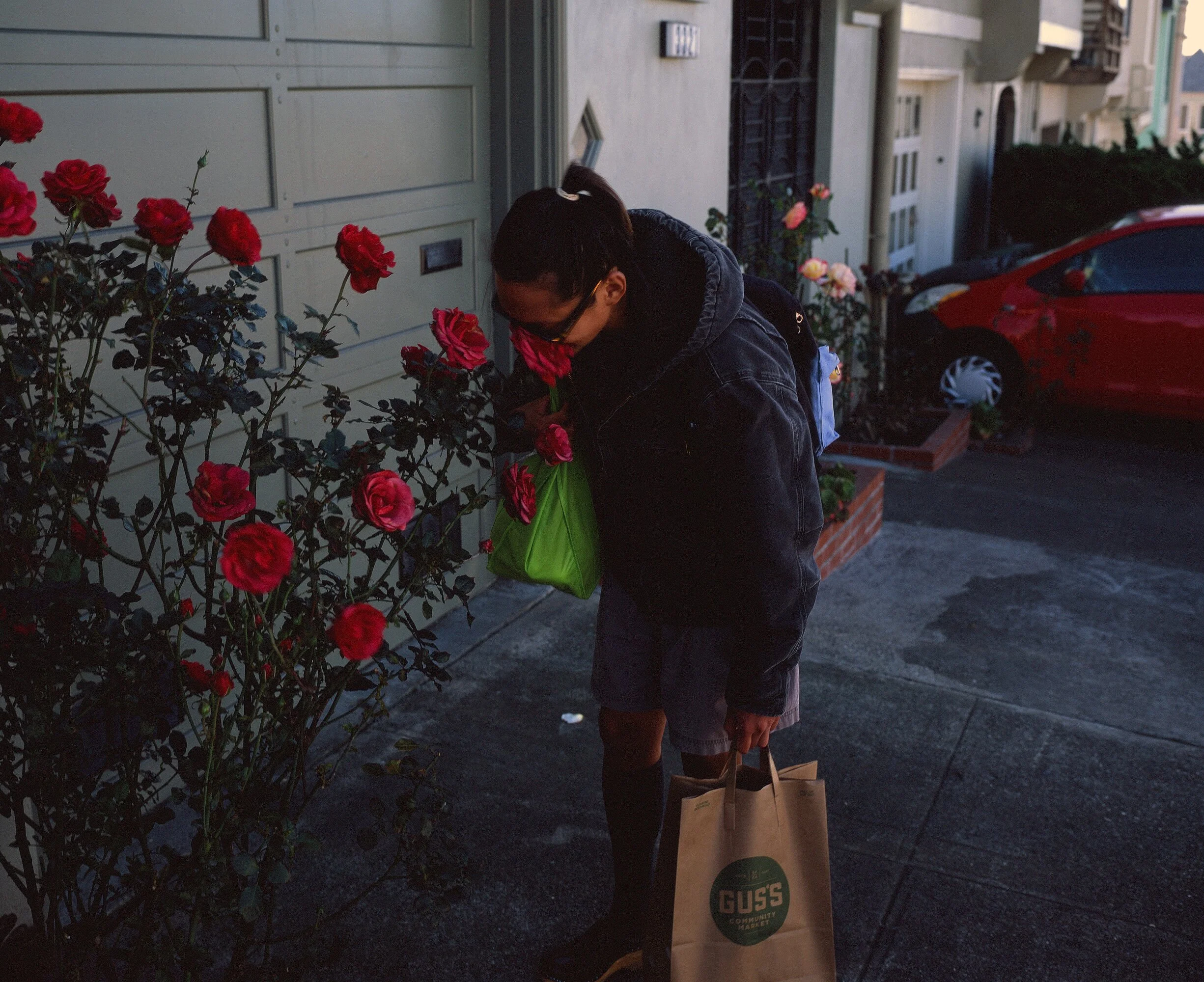 A friend smelling a rose on the street in San Francisco in 2016