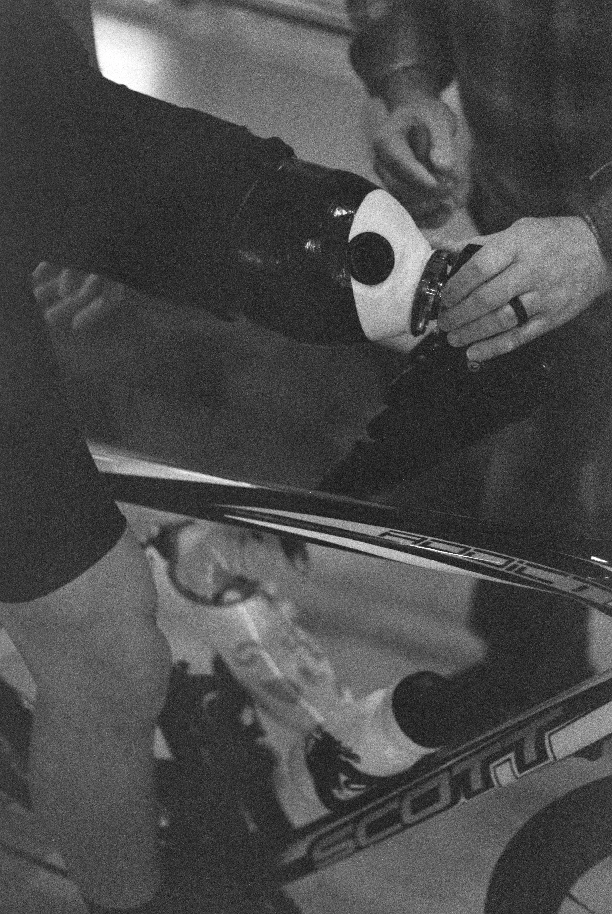 a closeup of John adjusting Dave's prosthesis while he's on the trainer