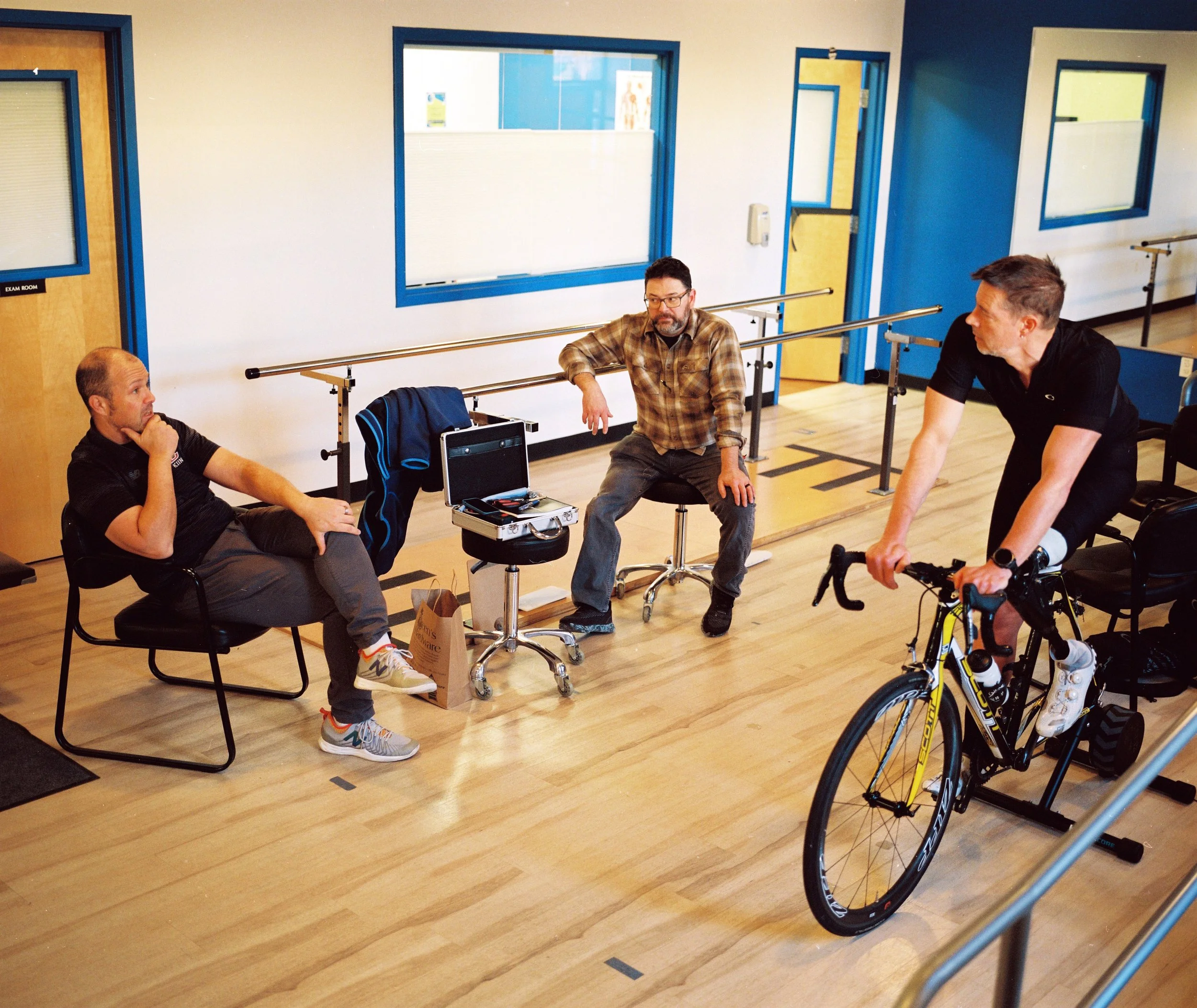 Mike and John sit and discuss while Dave is on the trainer