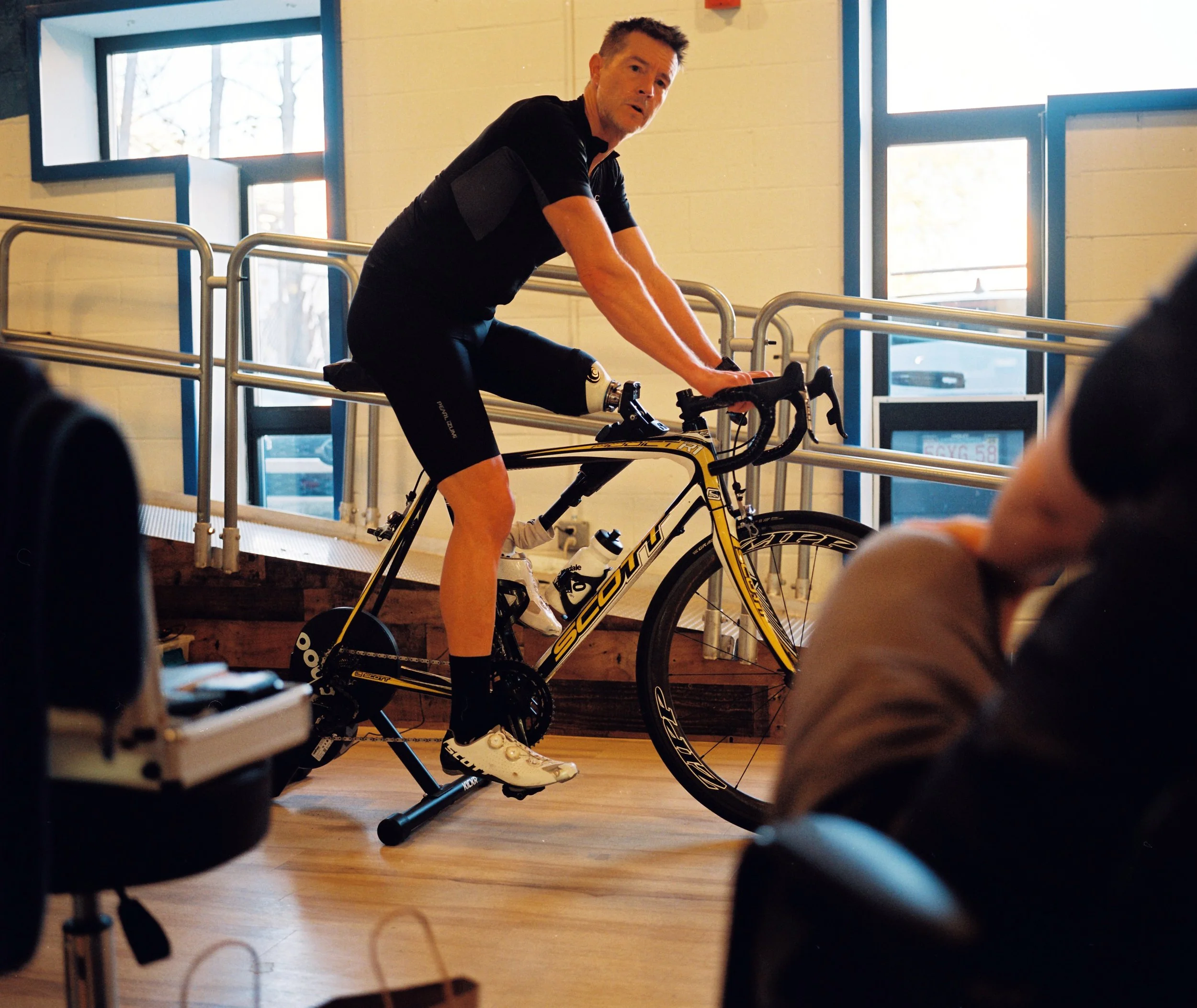 Dave Cummings tests new settings on his indoor trainer at his prosthetist's office