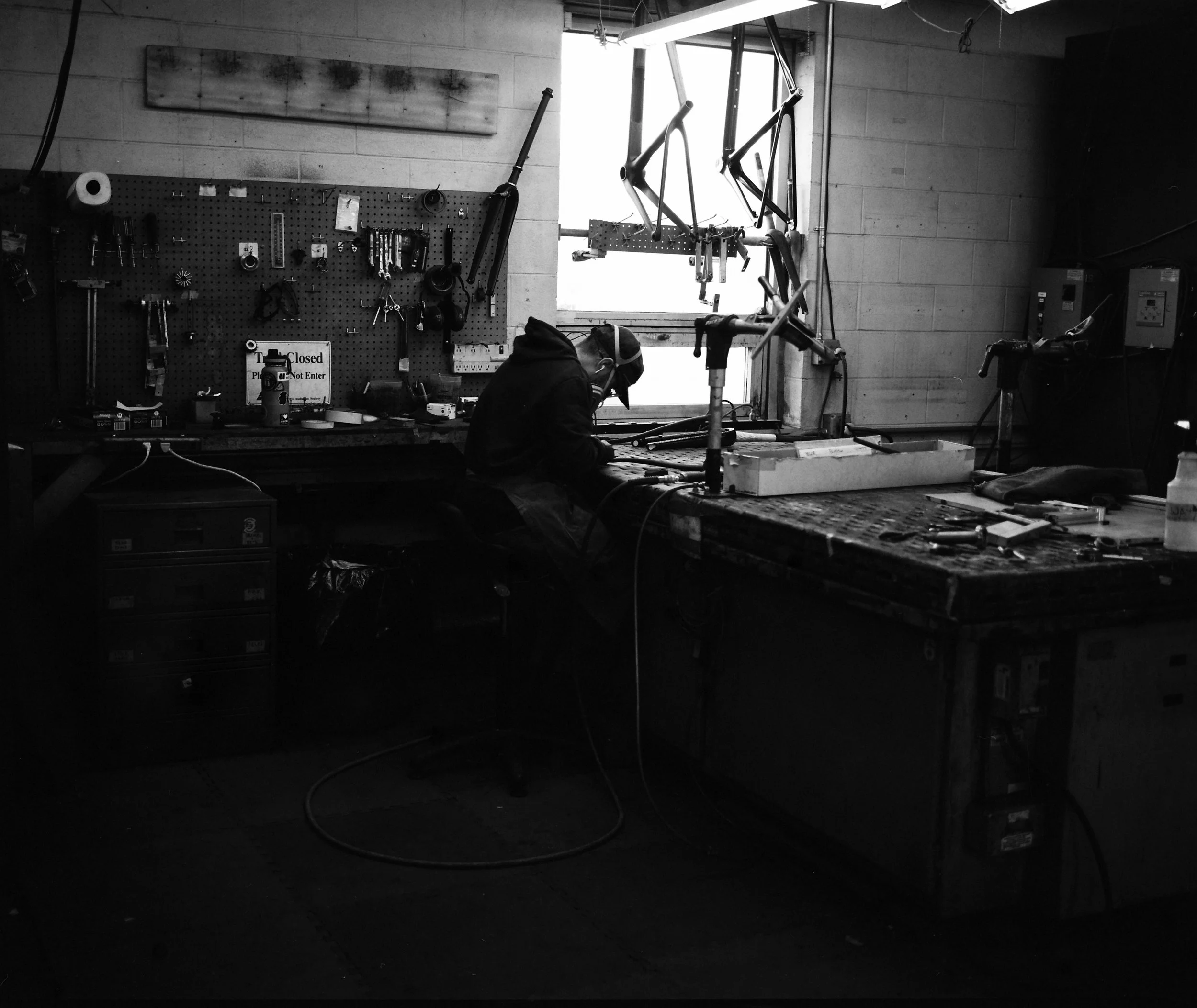 A Parlee team member works on a fork at the bench