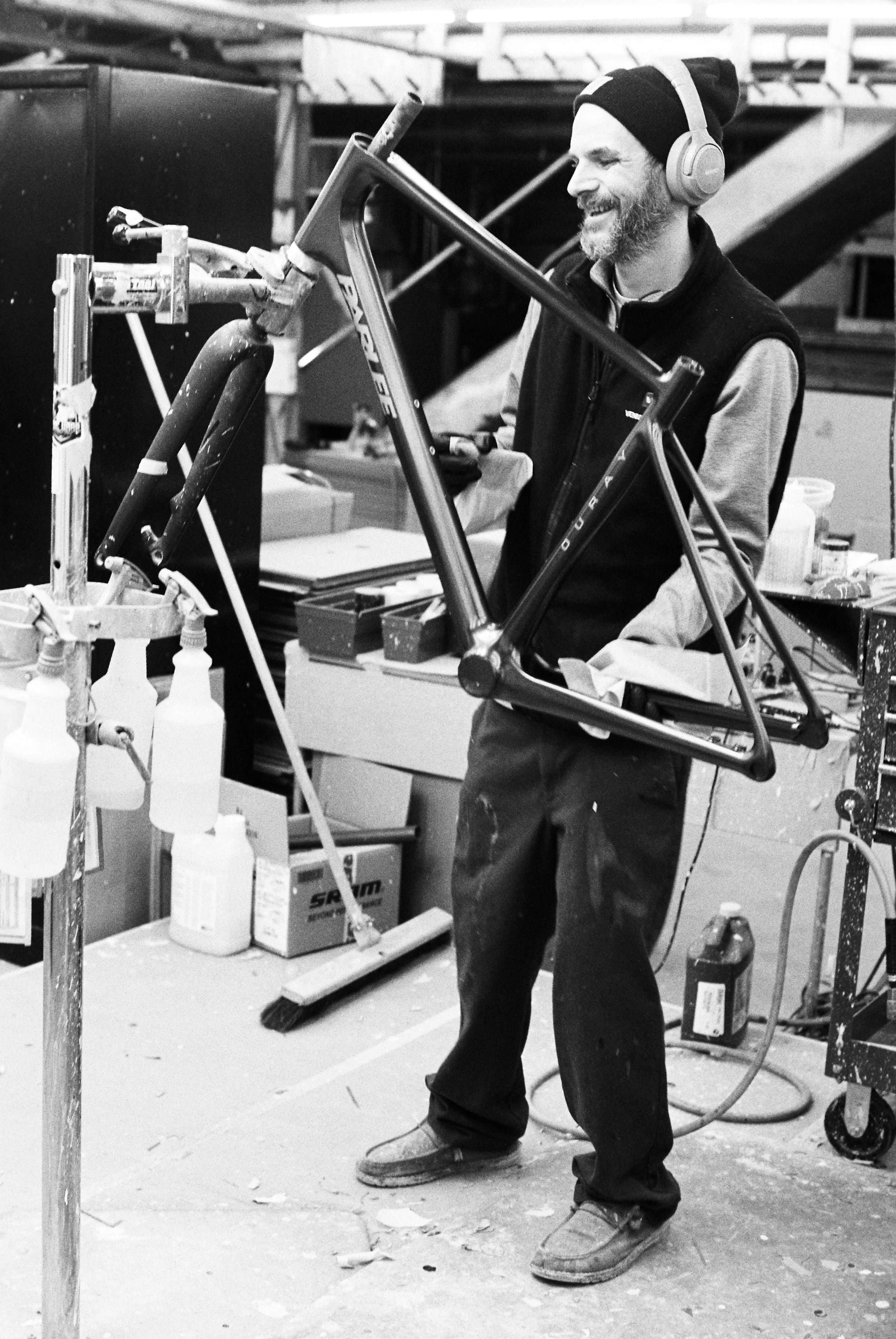 Parlee painter, Cody Haight smiles as he wipes down a freshly painted frame at Parlee headquarters