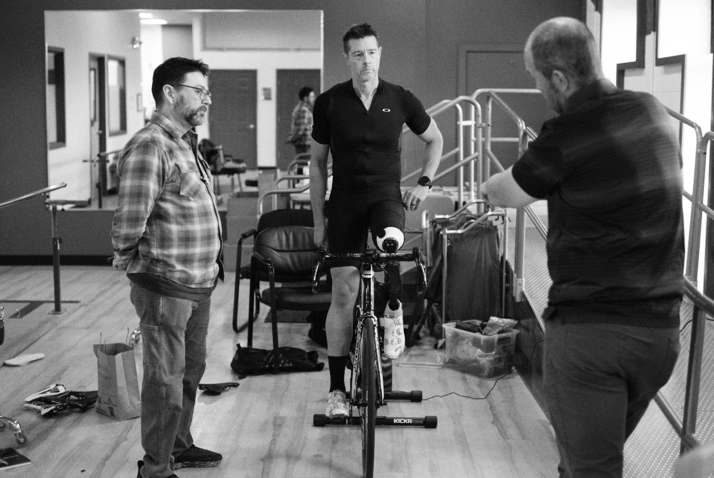 Dave, John, and Mike discuss Dave's prosthesis and bike settings in John's office