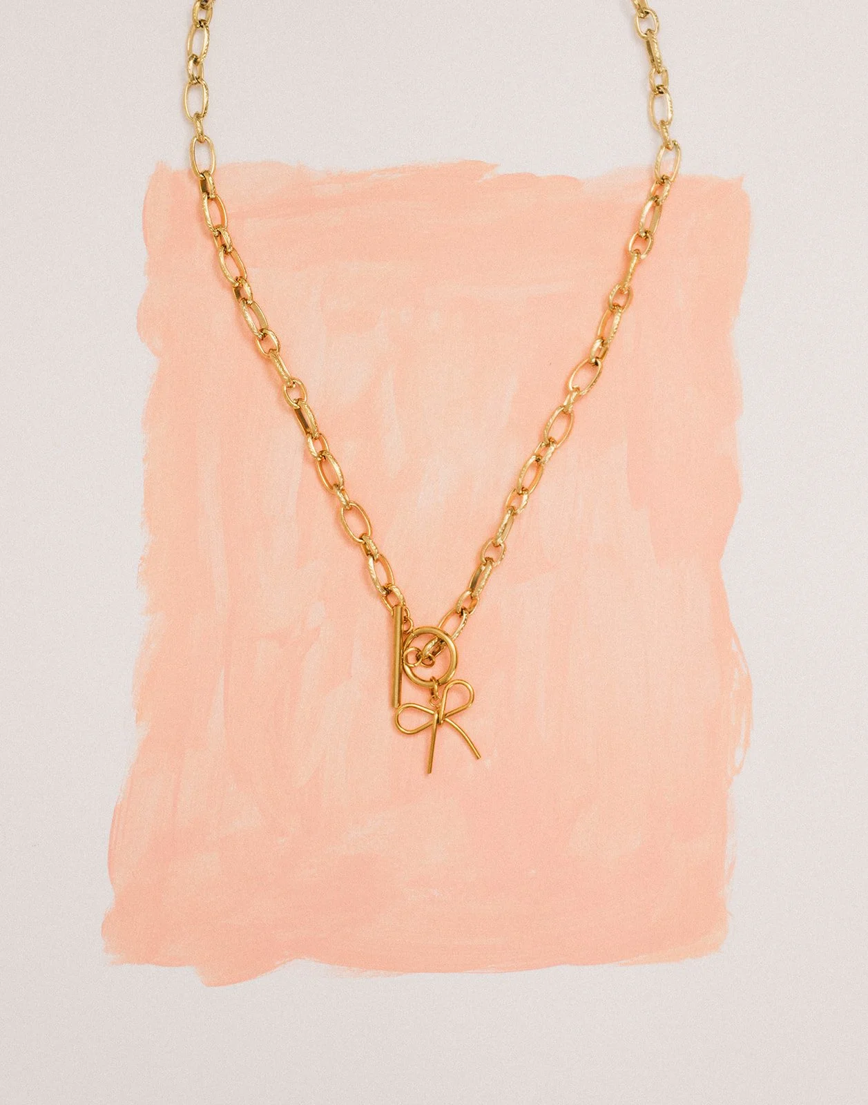 Necklase-on-pink-painted-paper-Mushaboom-Studio.jpg