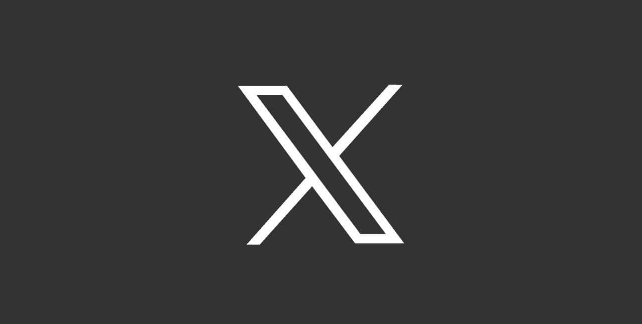 A minimalist black background with a white stylized letter 'X' logo in the center.