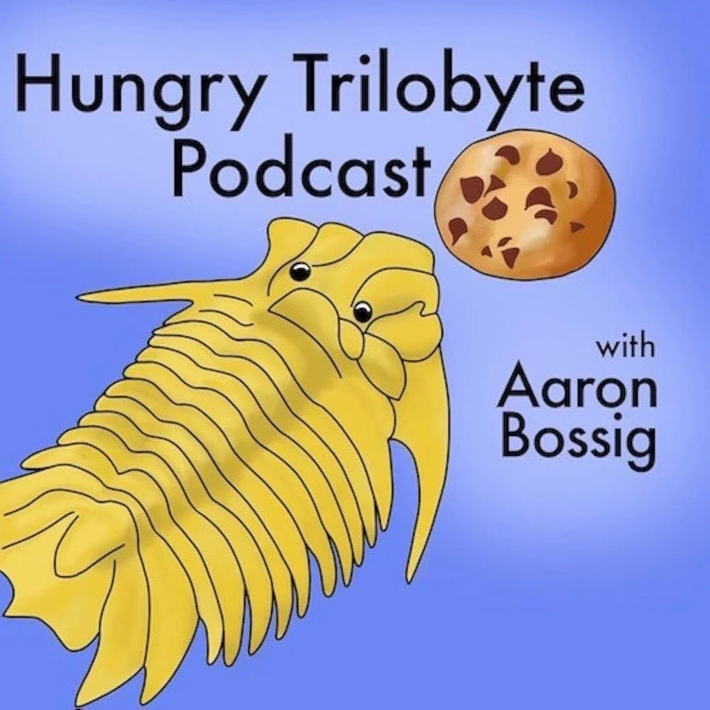 Illustration of a trilobyte with cartoon eyes and a cookie above, with text reading "Hungry Trilobyte Podcast with Aaron Bossig" on a blue background.