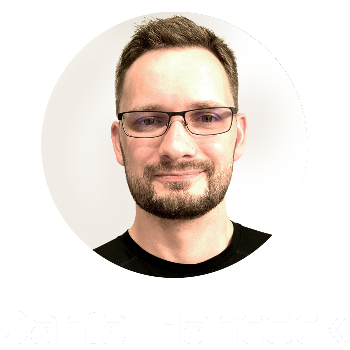 A man with short brown hair, glasses, and a beard, smiling, wearing a black shirt, with the name 'Daniel Hancock' written below.