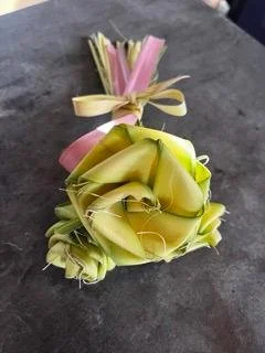 Handwoven palm roses with pink ribbon tag for awareness keepsake