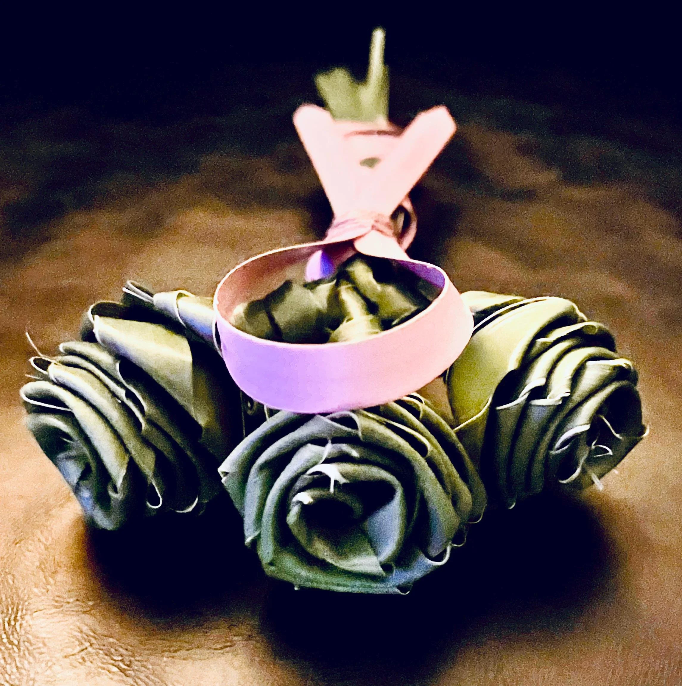Palm rose flowers with pink ribbon symbolic gift of hope and courage